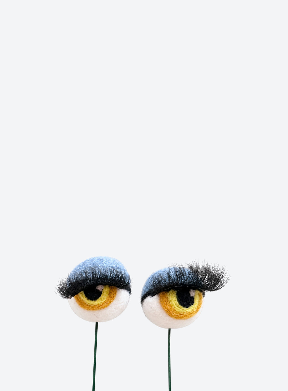 Felt eyeball plant stakes with colorful eyeshadow, eyelashes, and floral wire stems