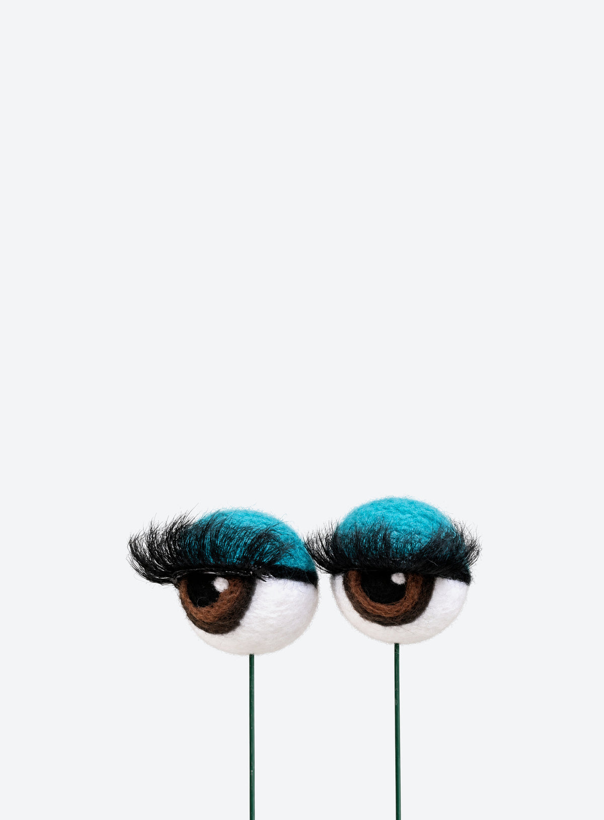 Felt eyeball plant stakes with colorful eyeshadow, eyelashes, and floral wire stems