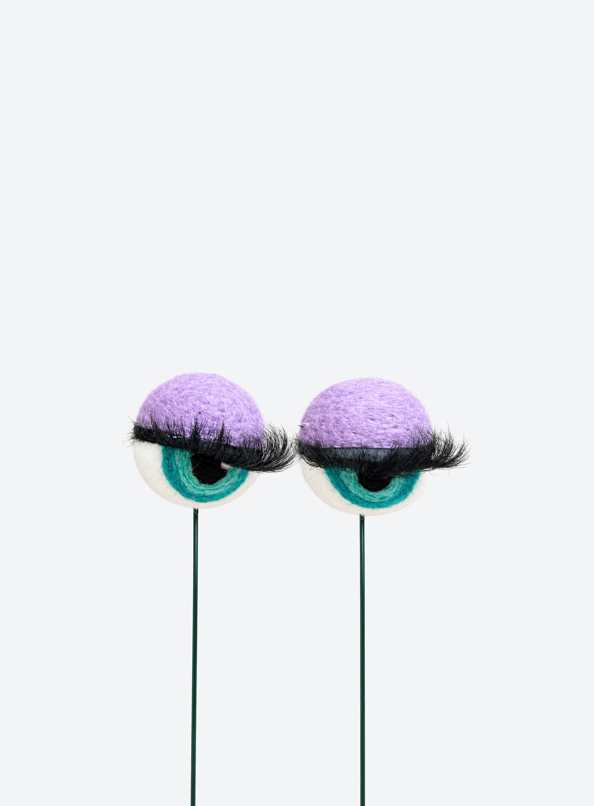 Felt eyeball plant stakes with colorful eyeshadow, eyelashes, and floral wire stems