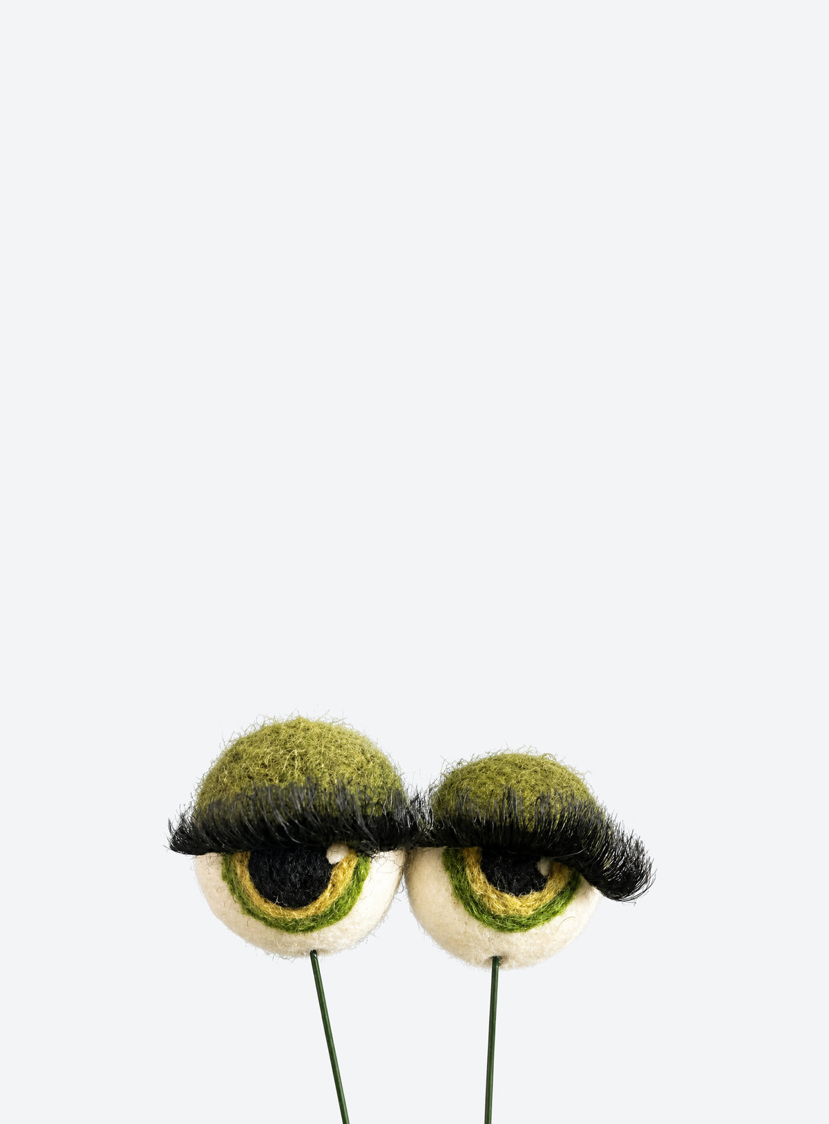 Felt eyeball plant stakes with colorful eyeshadow, eyelashes, and floral wire stems