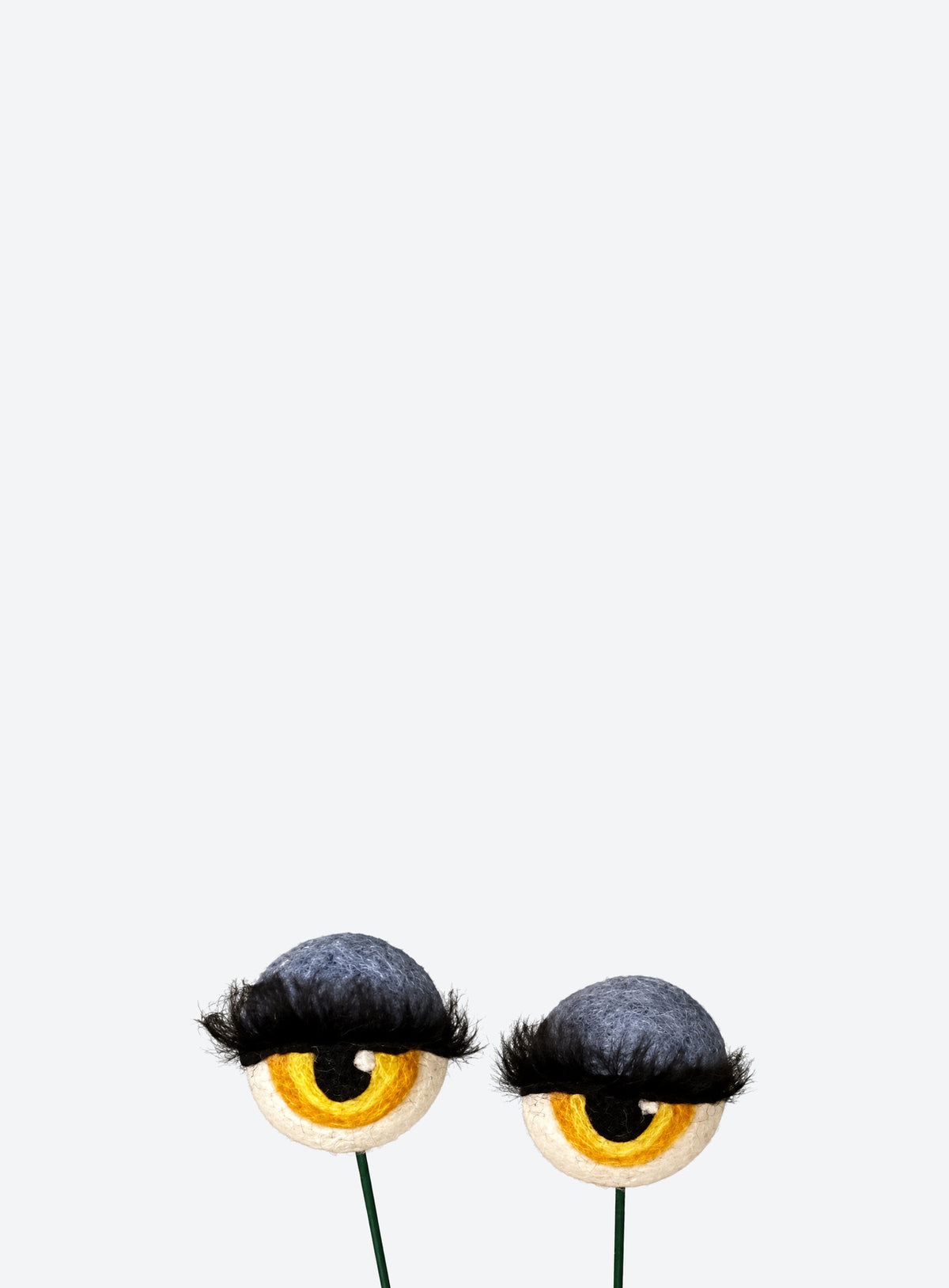 Felt eyeball plant stakes with colorful eyeshadow, eyelashes, and floral wire stems