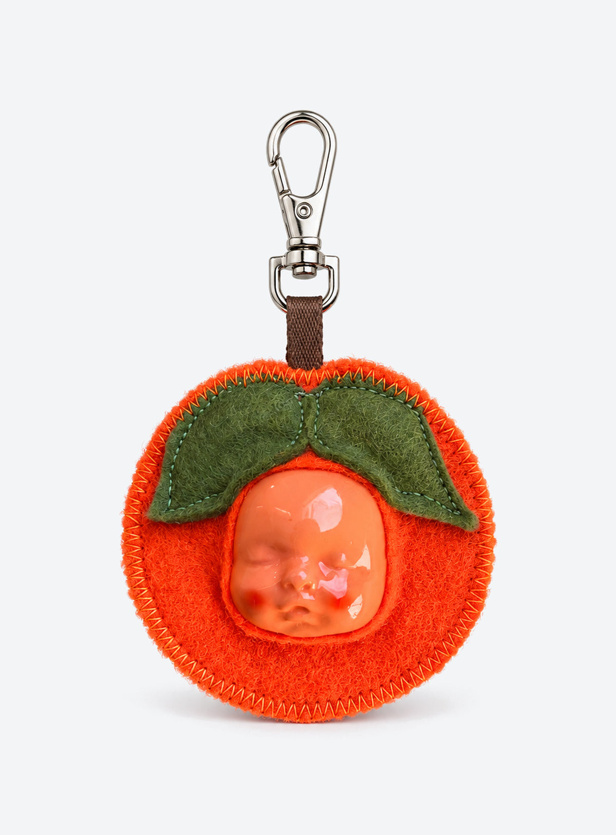 Handmade orange-shaped felt bag charm with a sculpted baby face, green leaves and a metal clasp