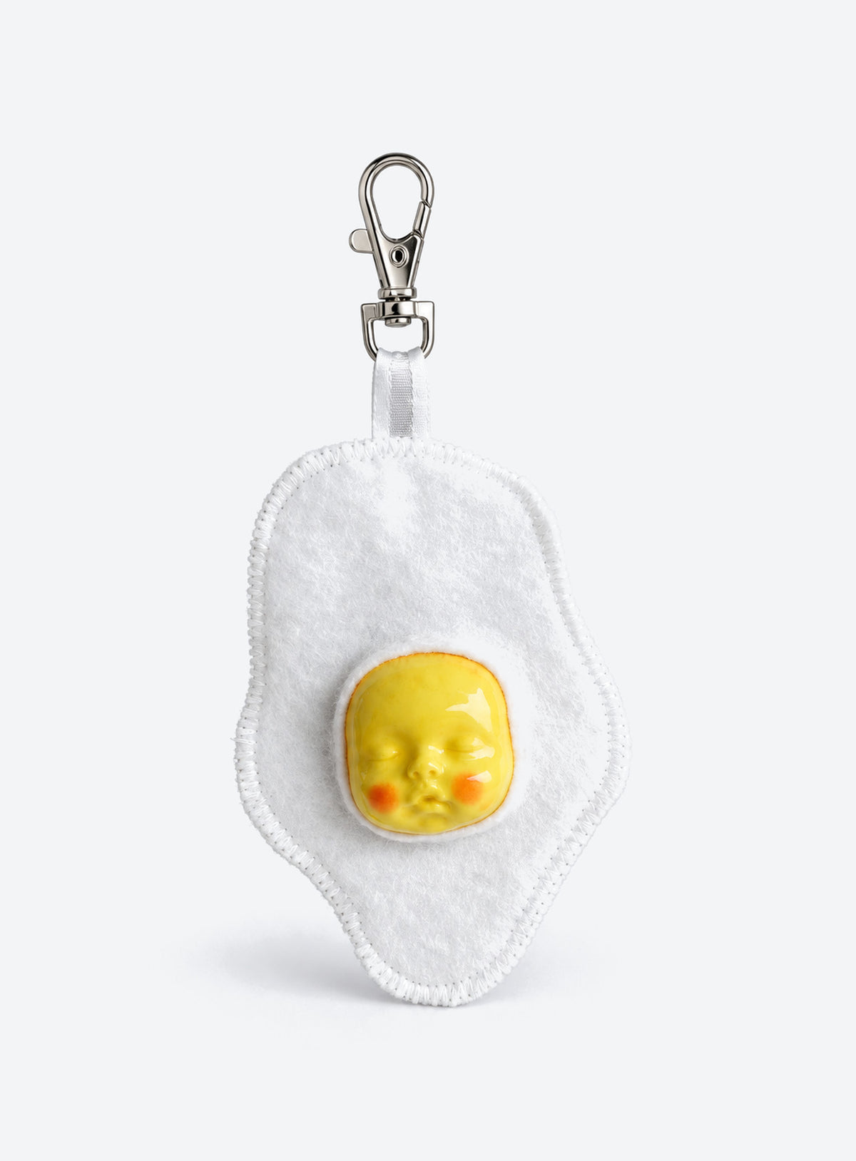 Handmade orange-shaped felt bag charm with a sculpted baby face, green leaves and a metal clasp