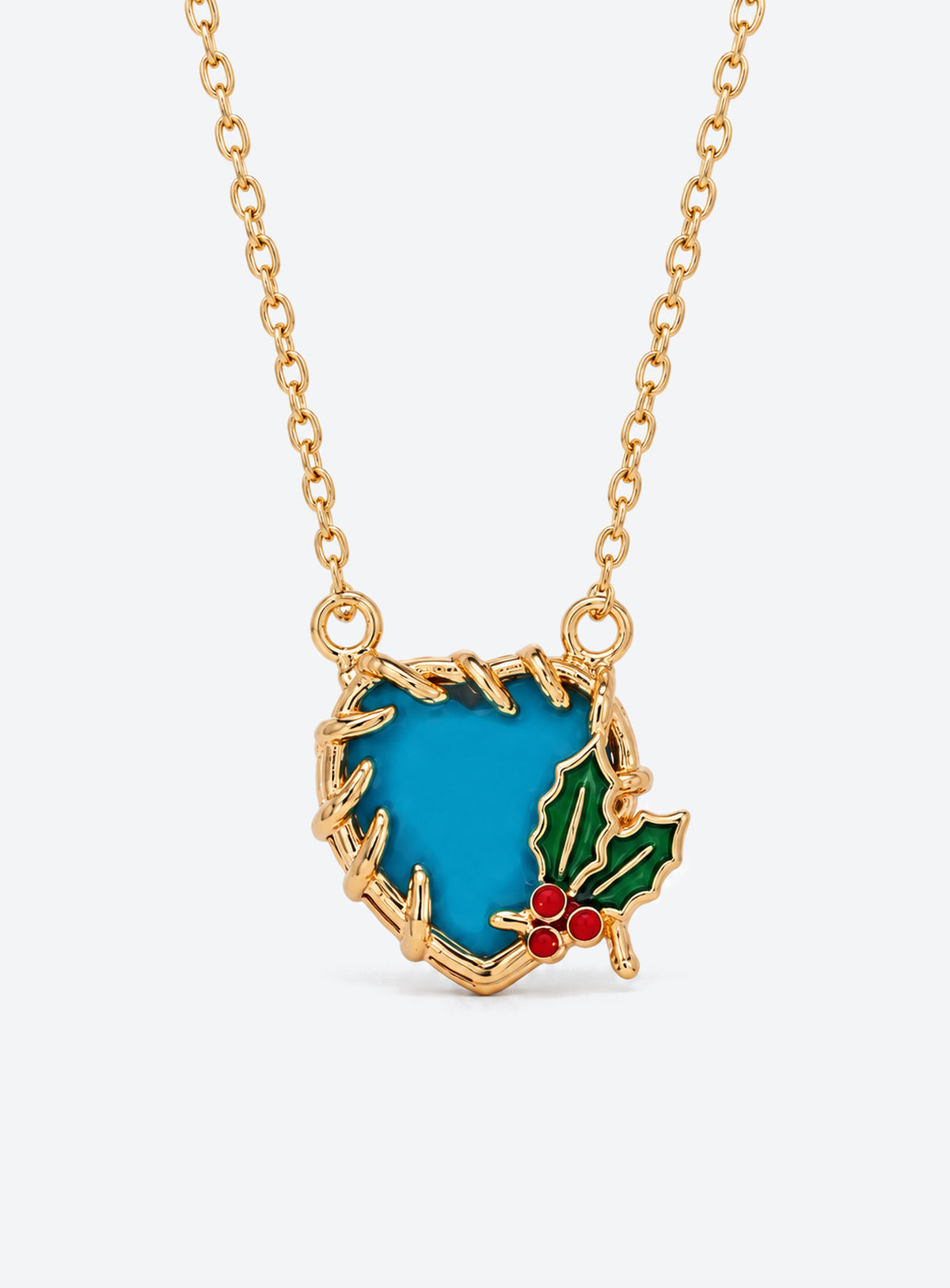 Heart-shaped crystal pendant necklace with enameled floral details and a gold-tone vine frame (December)