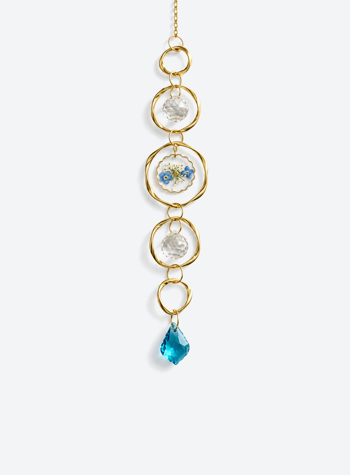 Hanging suncatcher with gold-colored rings, clear faceted balls, a blue-and-white flower detail, and a teardrop pendant. (Blue)