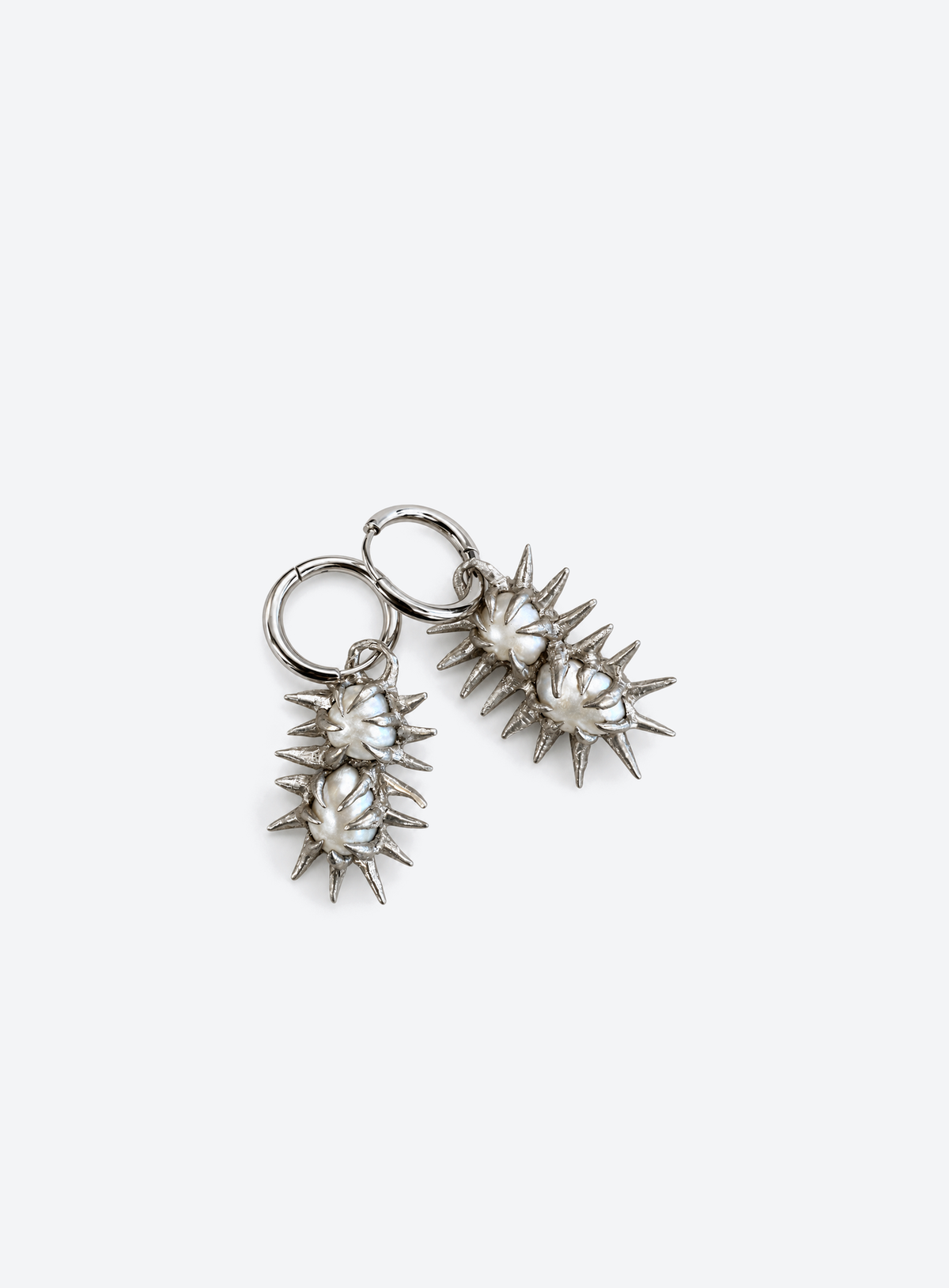 Silver-tone hoop earrings with freshwater pearls and pointed spikes