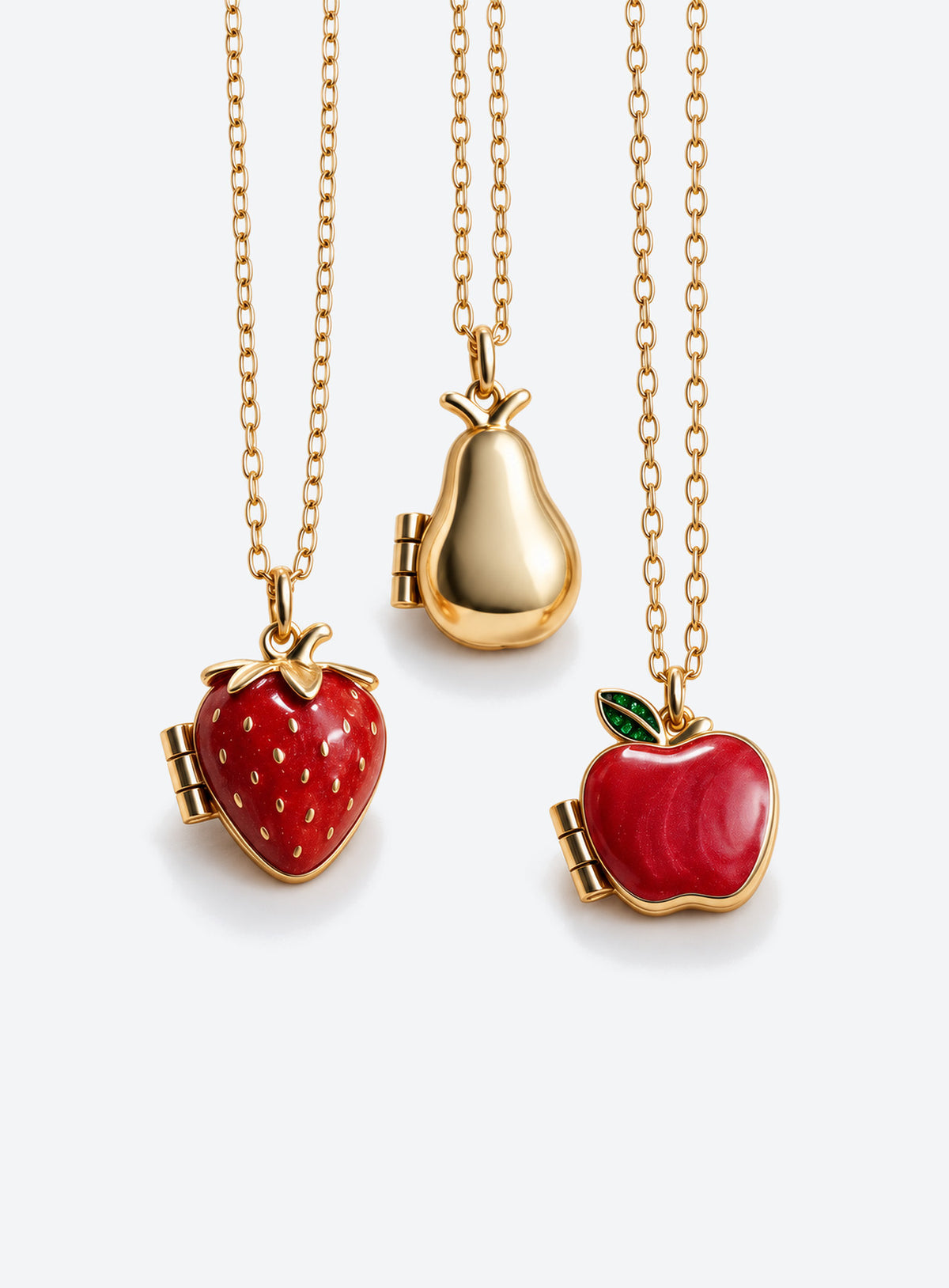 Fruit locket necklace in pear, red strawberry with raised seeds, or red apple with a green leaf styles