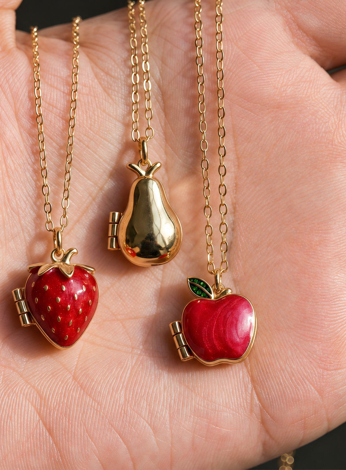 Fruit locket necklace in pear, red strawberry with raised seeds, or red apple with a green leaf styles
