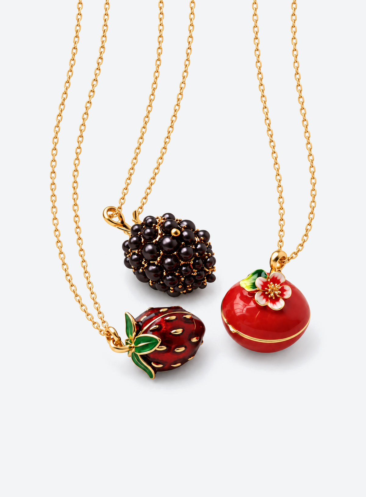 Fruit-shaped locket necklace with glossy enamel, gold-tone details, and a tiny mouse inside