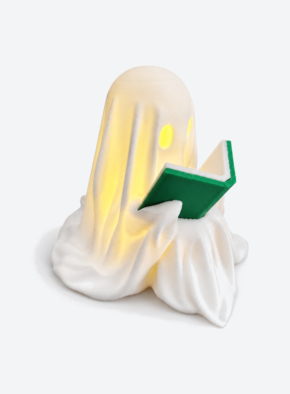 White ghost reading green book with LED tealight lantern
