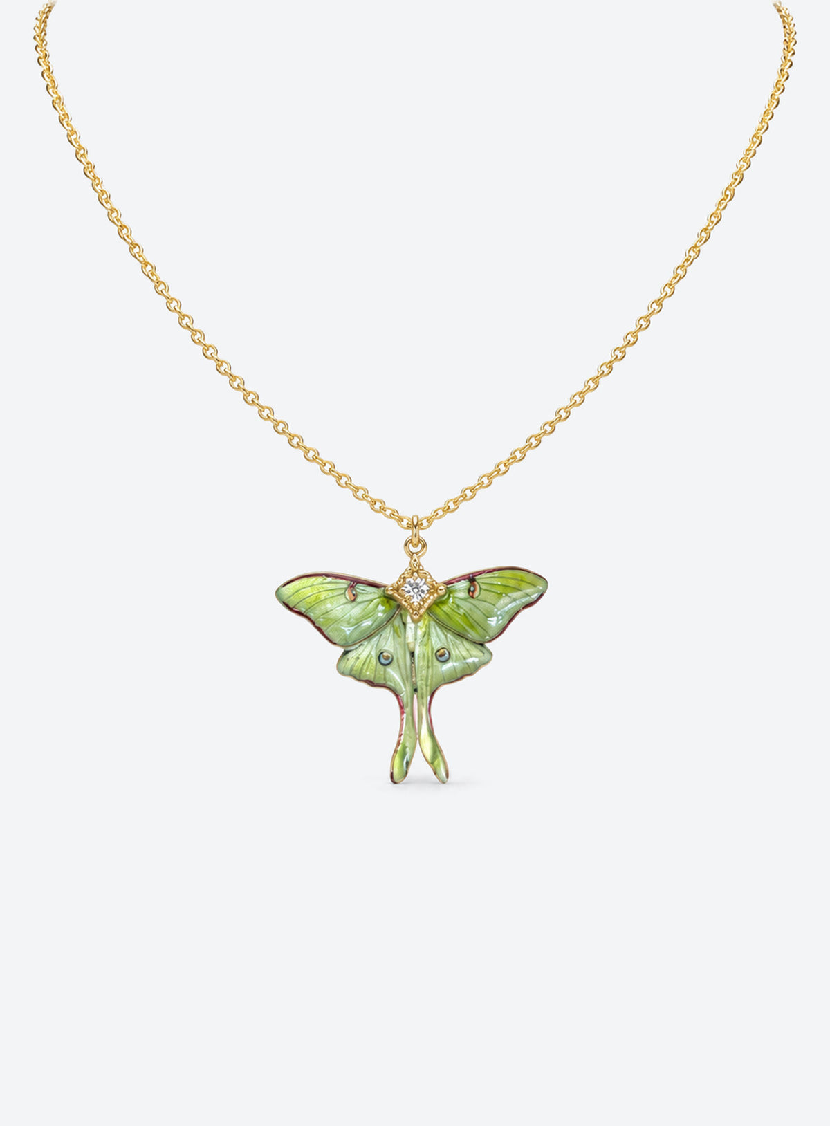 Pearlescent green luna moth pendant with painted wing details, two long tails, and clear body rhinestones