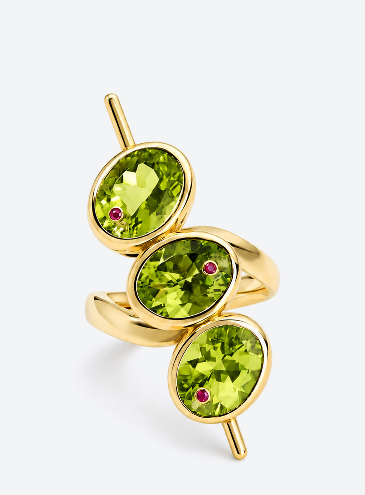 Gold-tone ring with three green oval faceted details, tiny red points and skewer-like side accents
