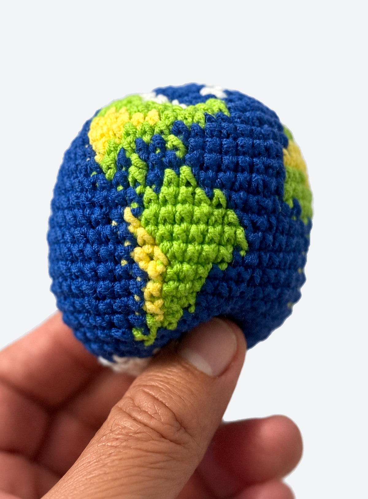Cotton crochet footbag with visible yarn stitches and a textured, rounded shape
