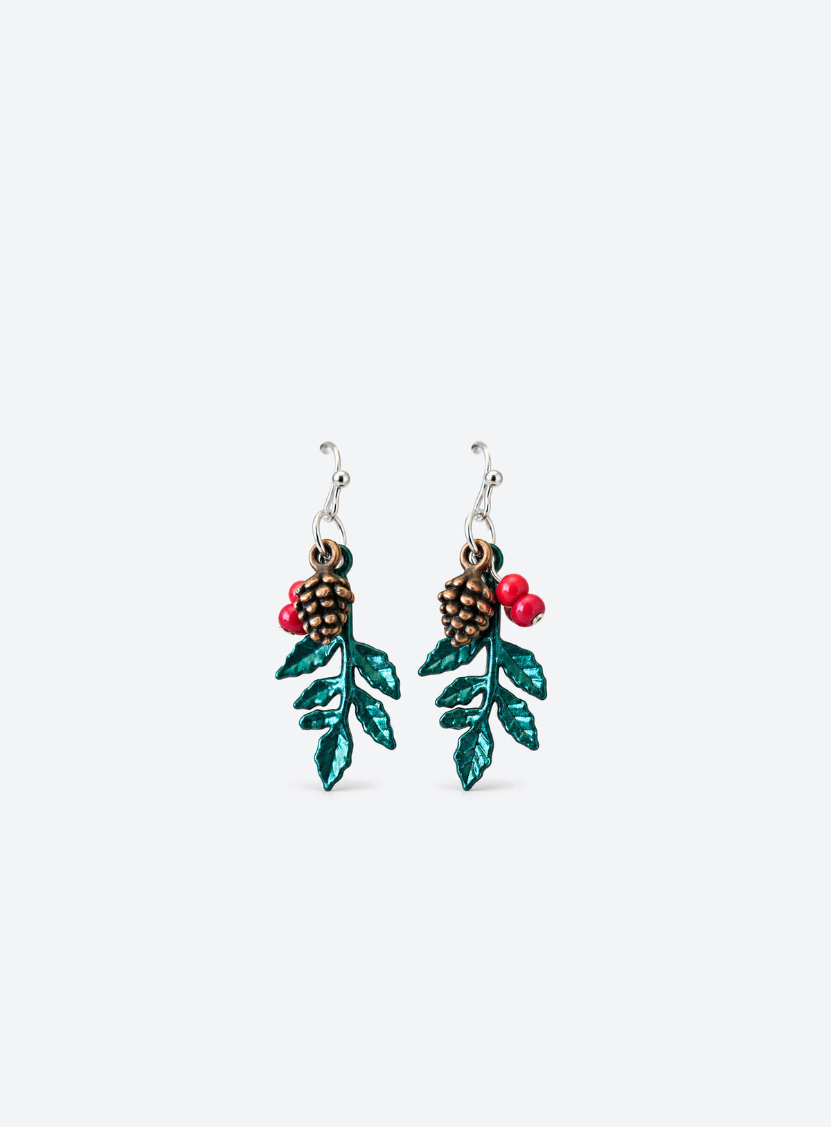 Drop earrings with green holly leaves, red berry beads, bronze-tone pinecones and silver-tone ball-hook ear wires.