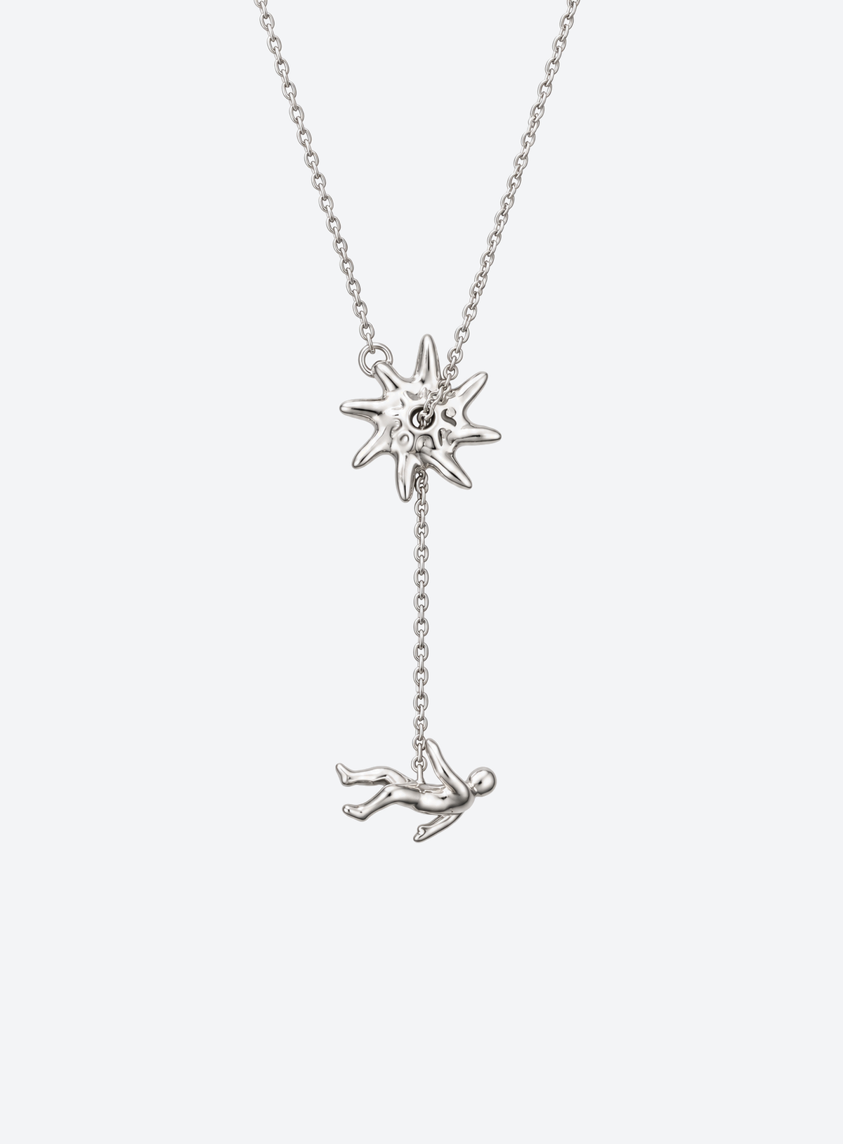 Y-shaped necklace with a hammered sunburst above a small falling figure