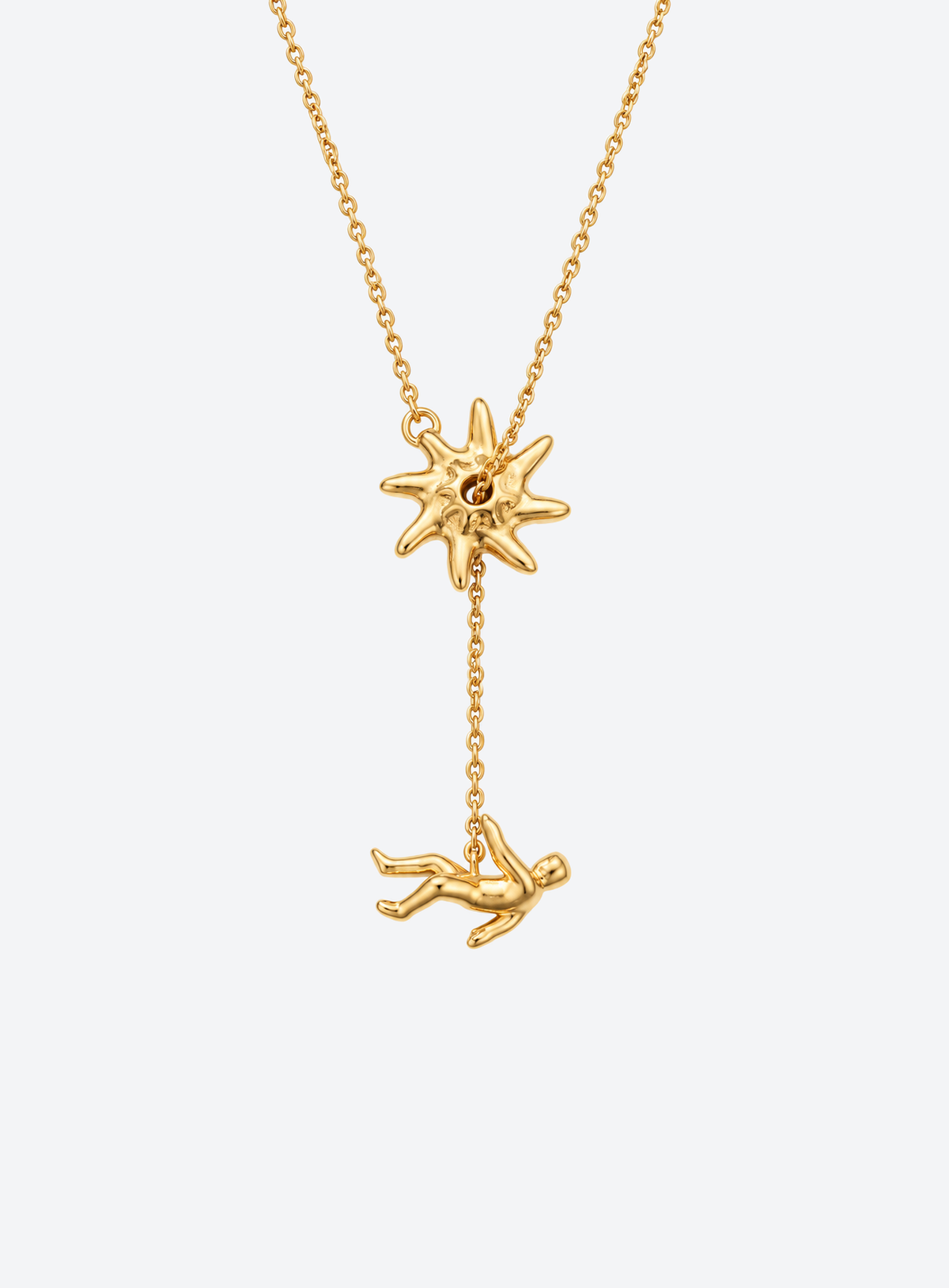 Y-shaped necklace with a hammered sunburst above a small falling figure