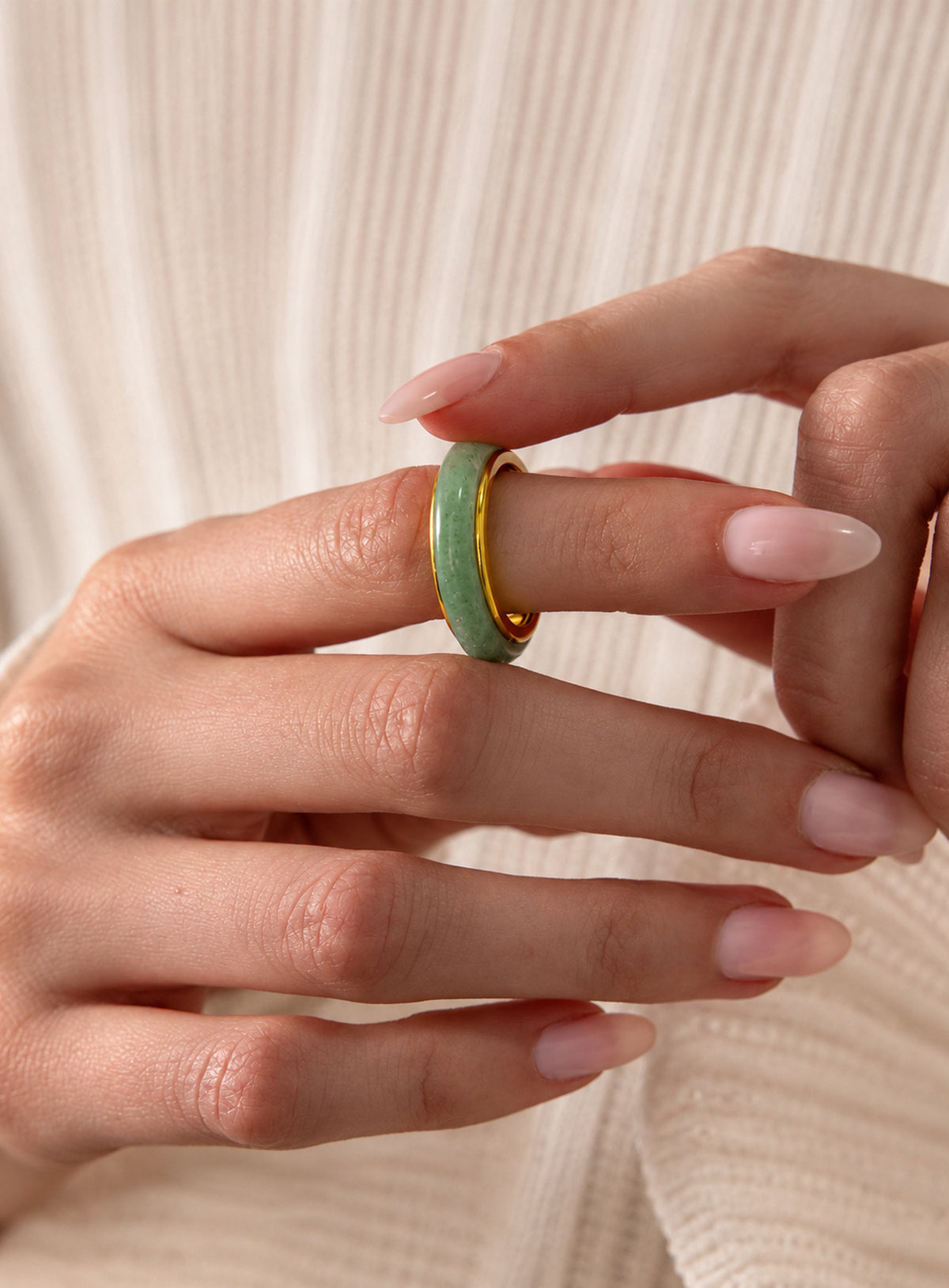 Green jade spinner ring with a gold-tone band
