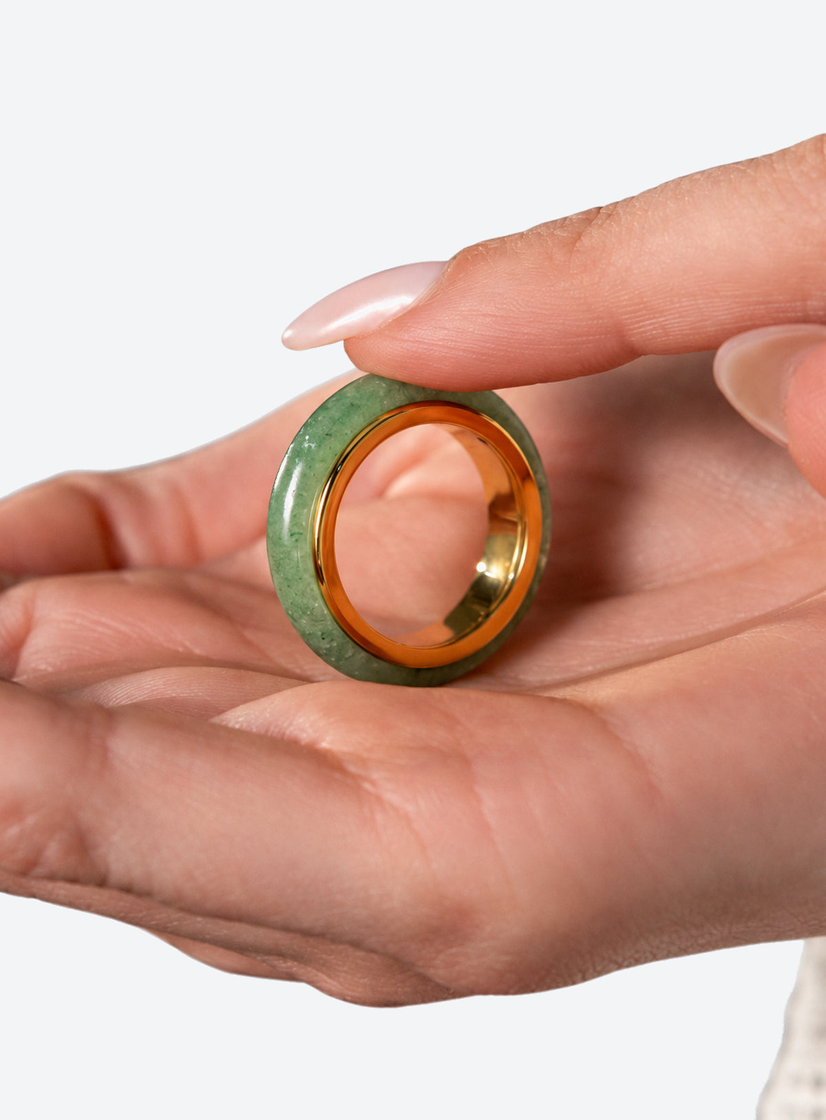 Green jade spinner ring with a gold-tone band