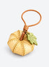 Pumpkin-shaped leather bag charm with stitched panels, a leaf accent, and a hanging loop