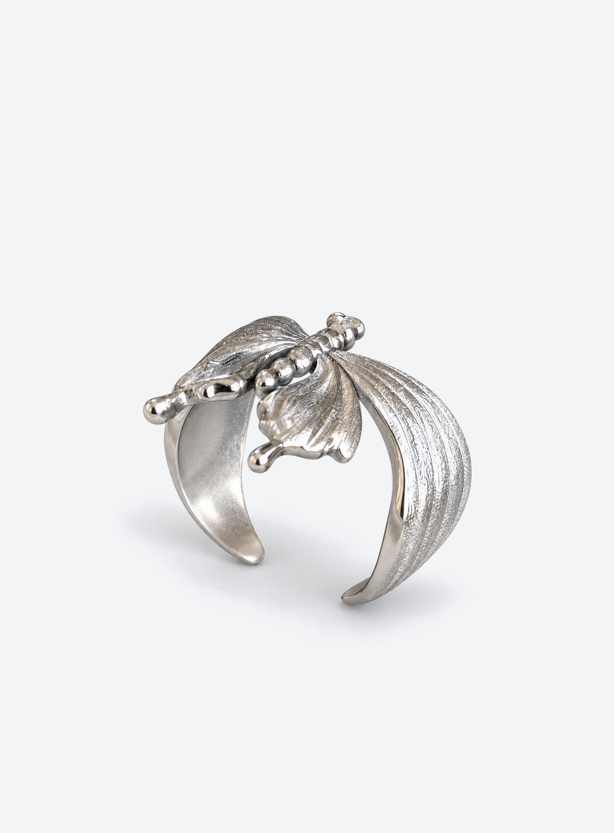 A silver-tone luna moth ring with brushed wings, polished tail details and an open wraparound band