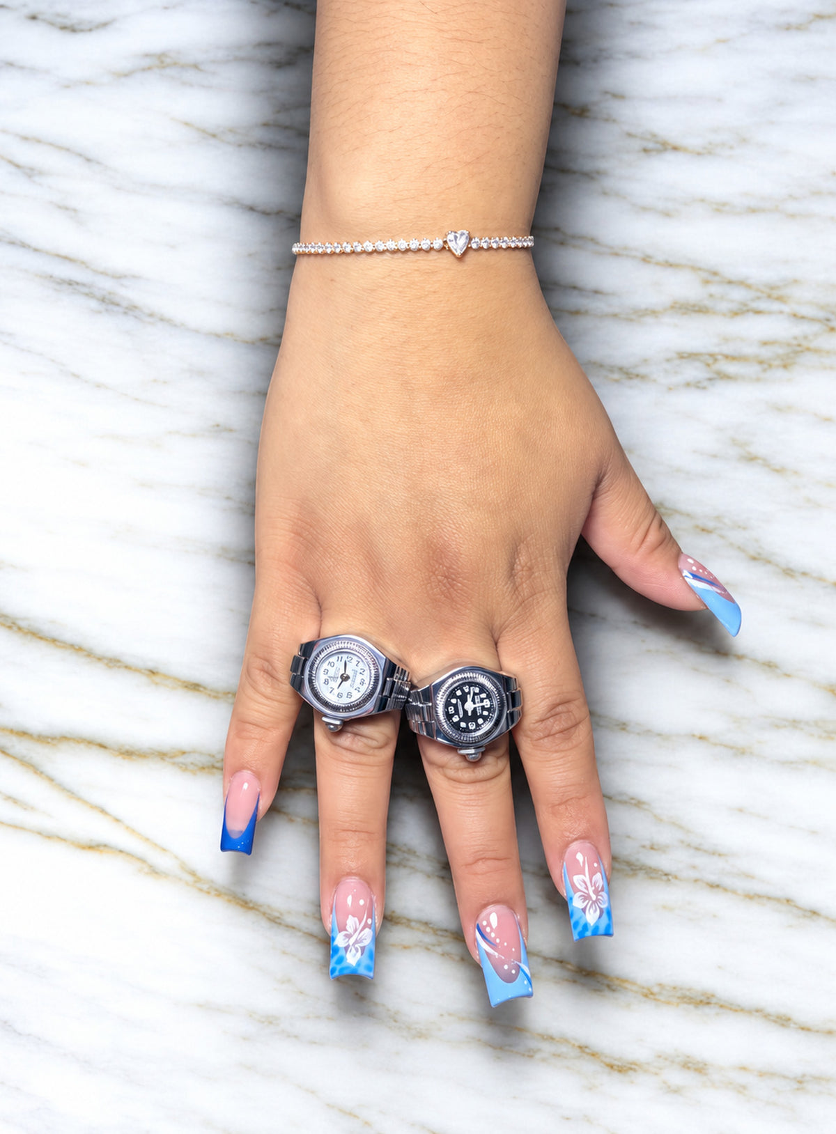 Silver-tone watch ring with a miniature analog dial and a flexible link band