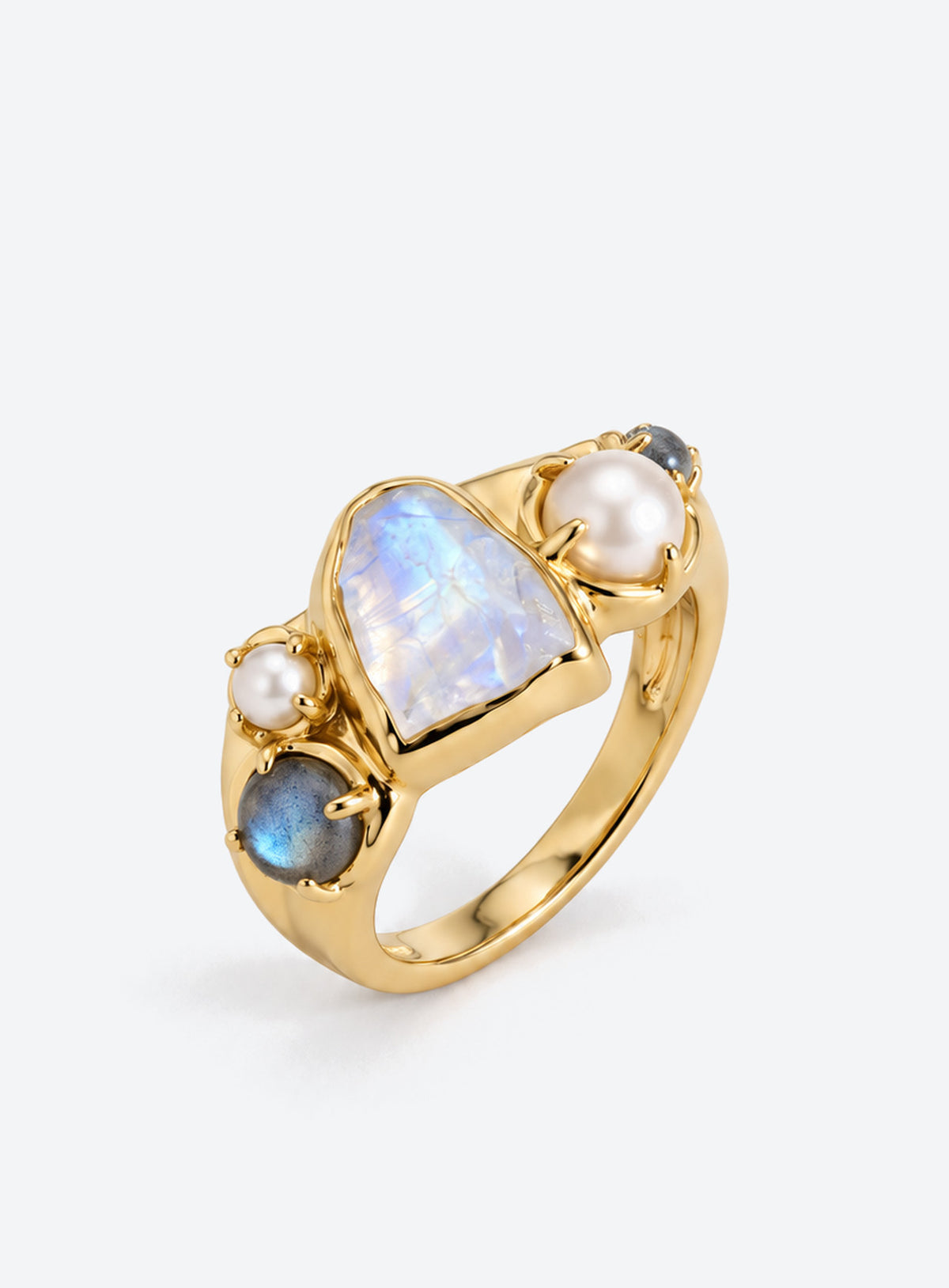 Gold-finish ring with a pale irregular moonstone, white pearls, and small blue-gray stones in an asymmetric cluster