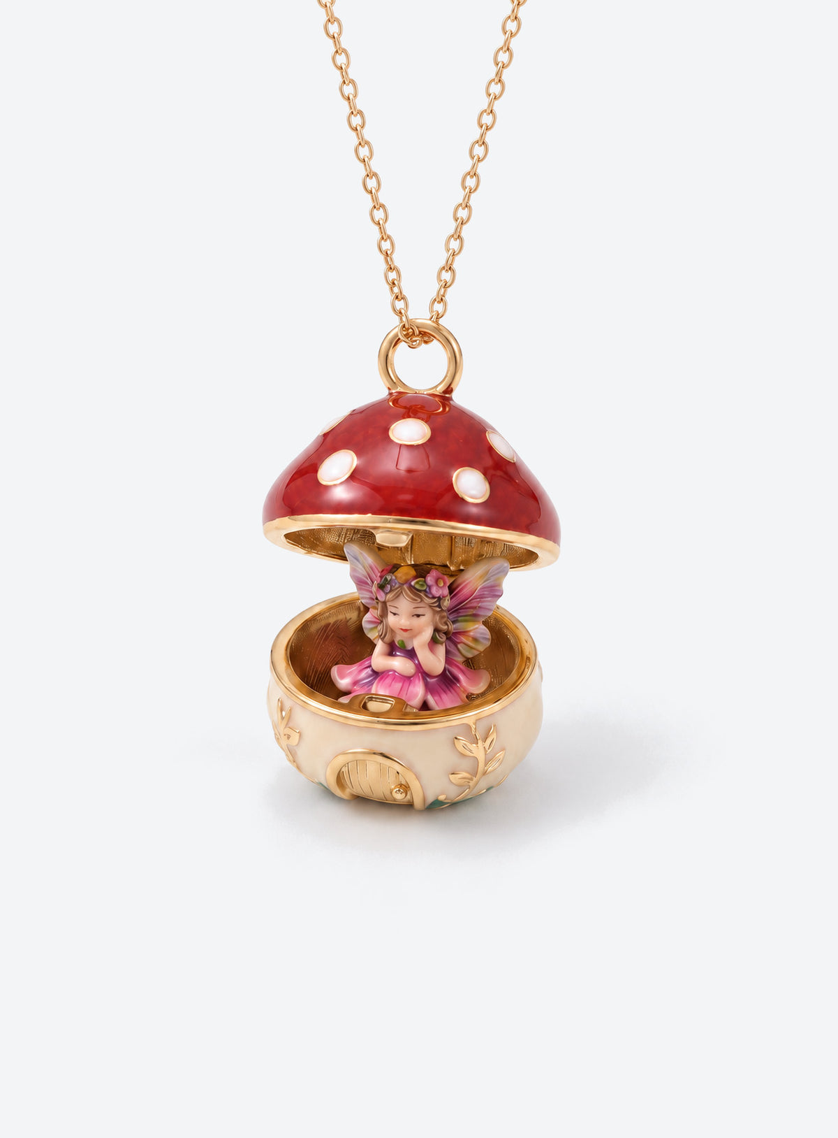 An open mushroom house pendant necklace with a miniature figure beneath its spotted enamel cap