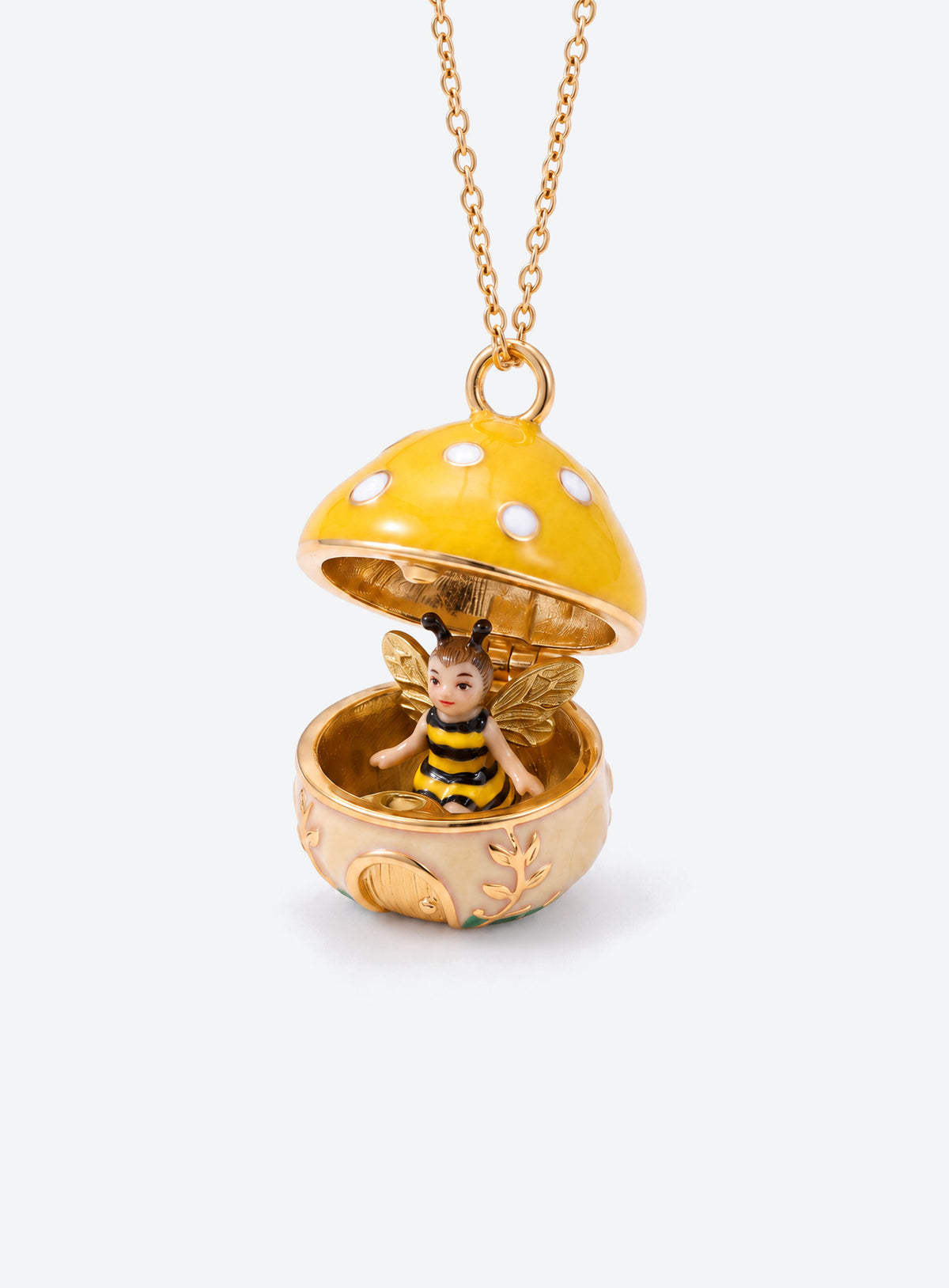 An open mushroom house pendant necklace with a miniature figure beneath its spotted enamel cap