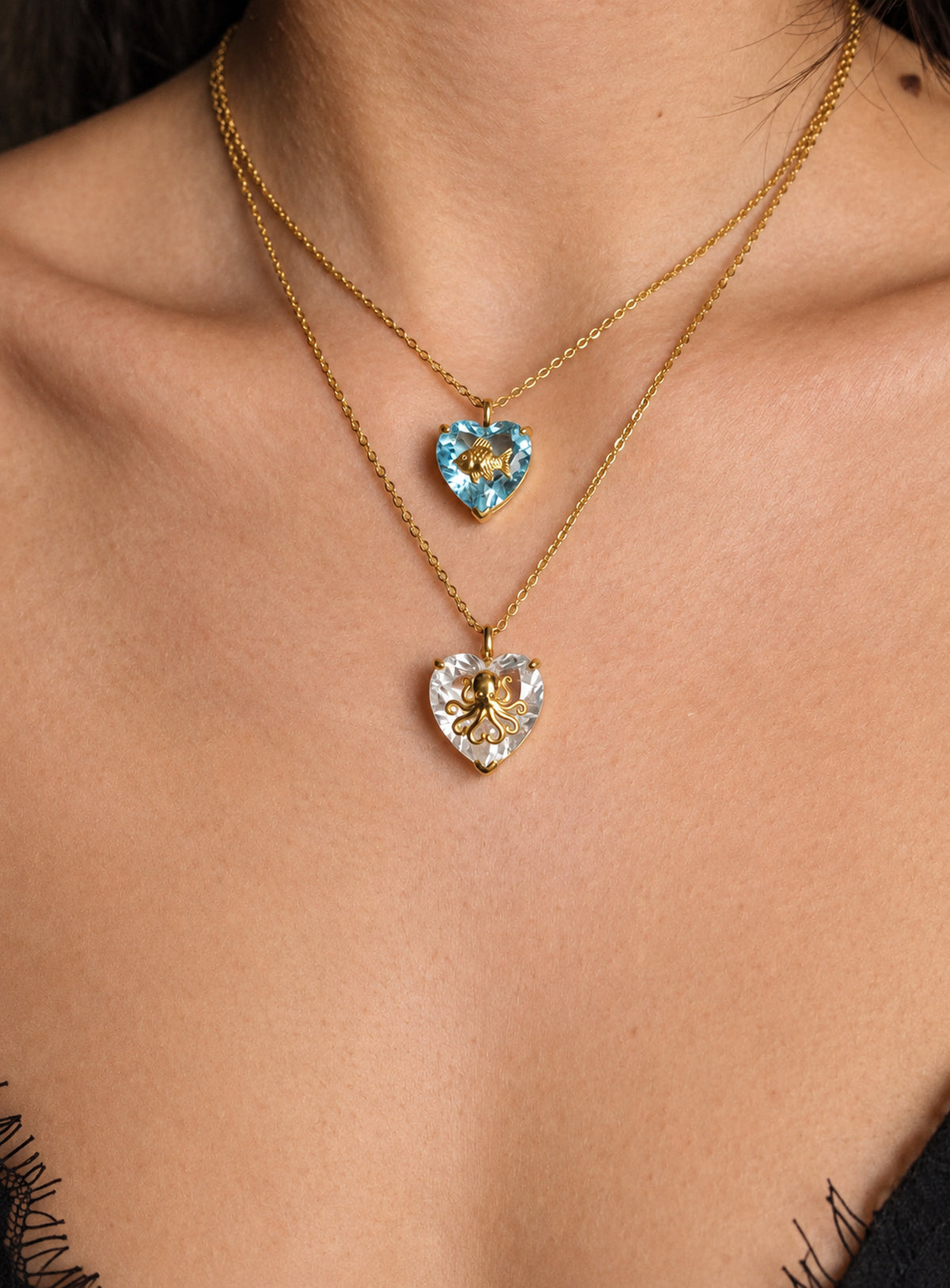 Heart-shaped crystal pendant necklace with a small gold-tone sea motif