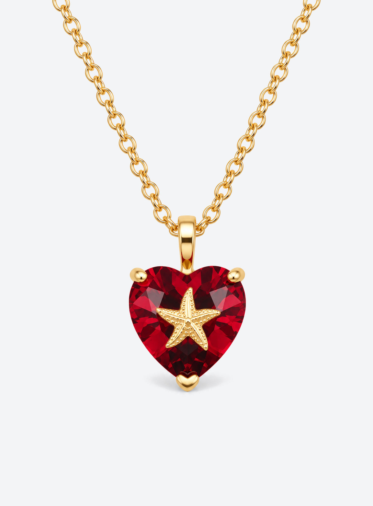 Heart-shaped crystal pendant necklace with a small gold-tone sea motif (July)