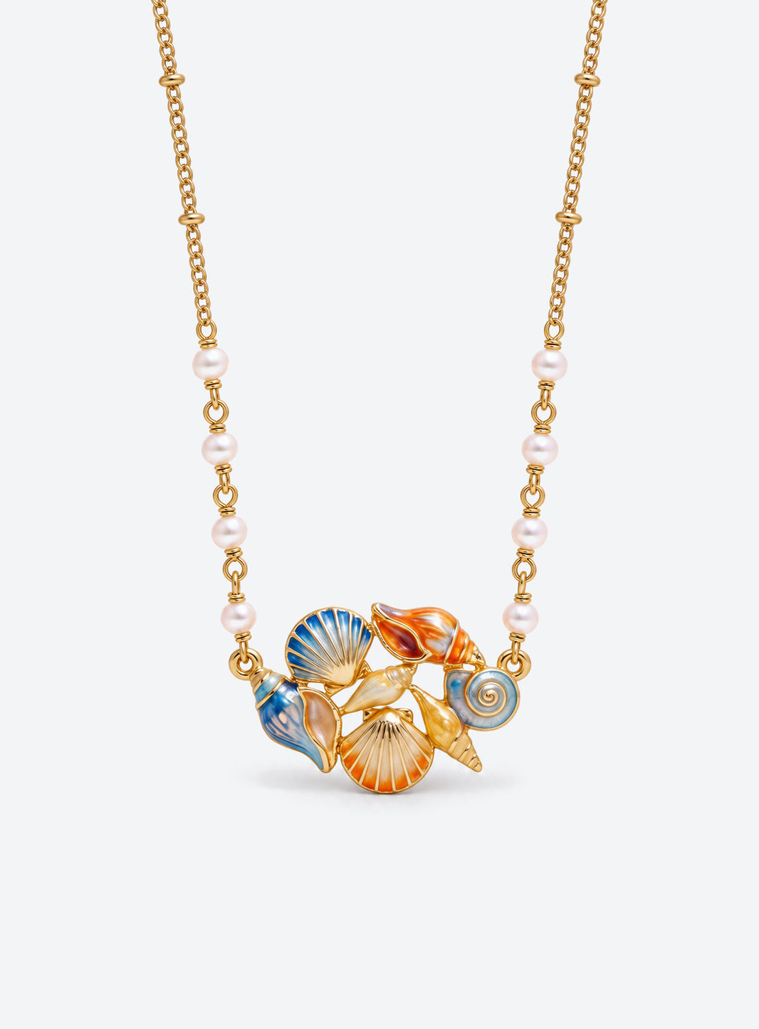 Ocean-themed necklace with a pearl station chain and a cluster of shells, sea creatures, or colorful fish (Conch Shell)