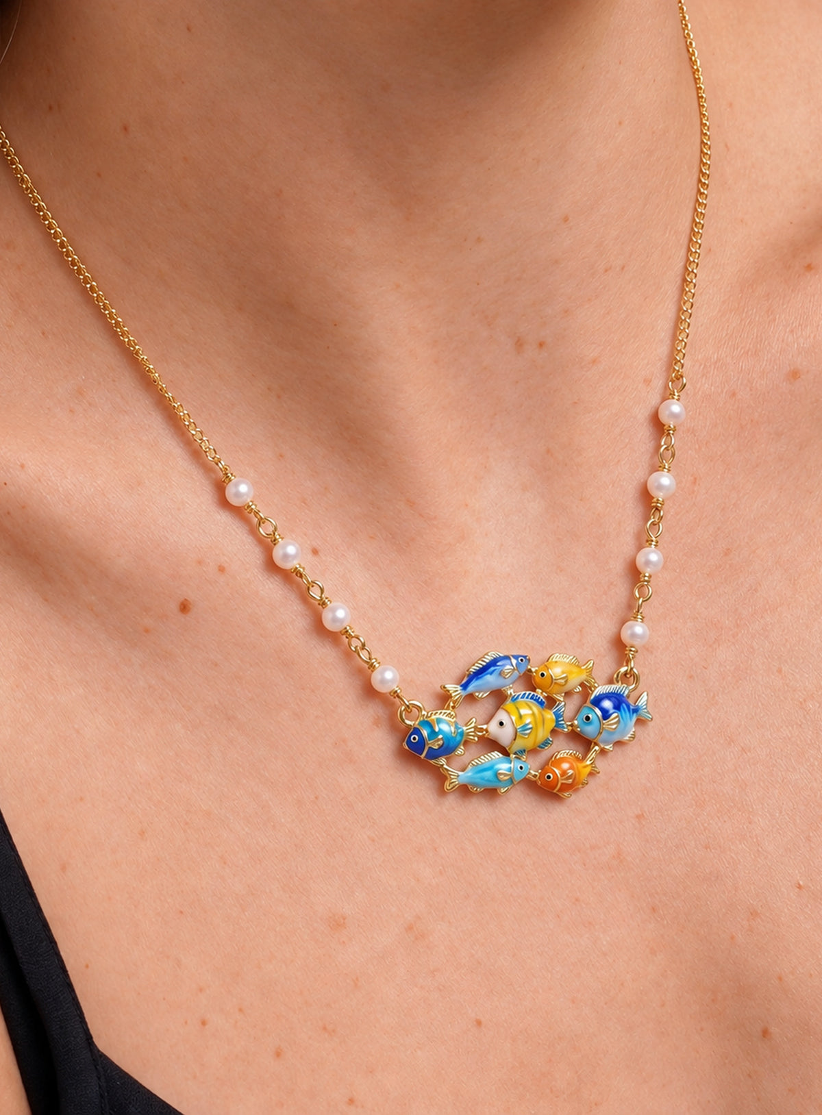Ocean-themed necklace with a pearl station chain and a cluster of shells, sea creatures, or colorful fish (Tropical Fish School)