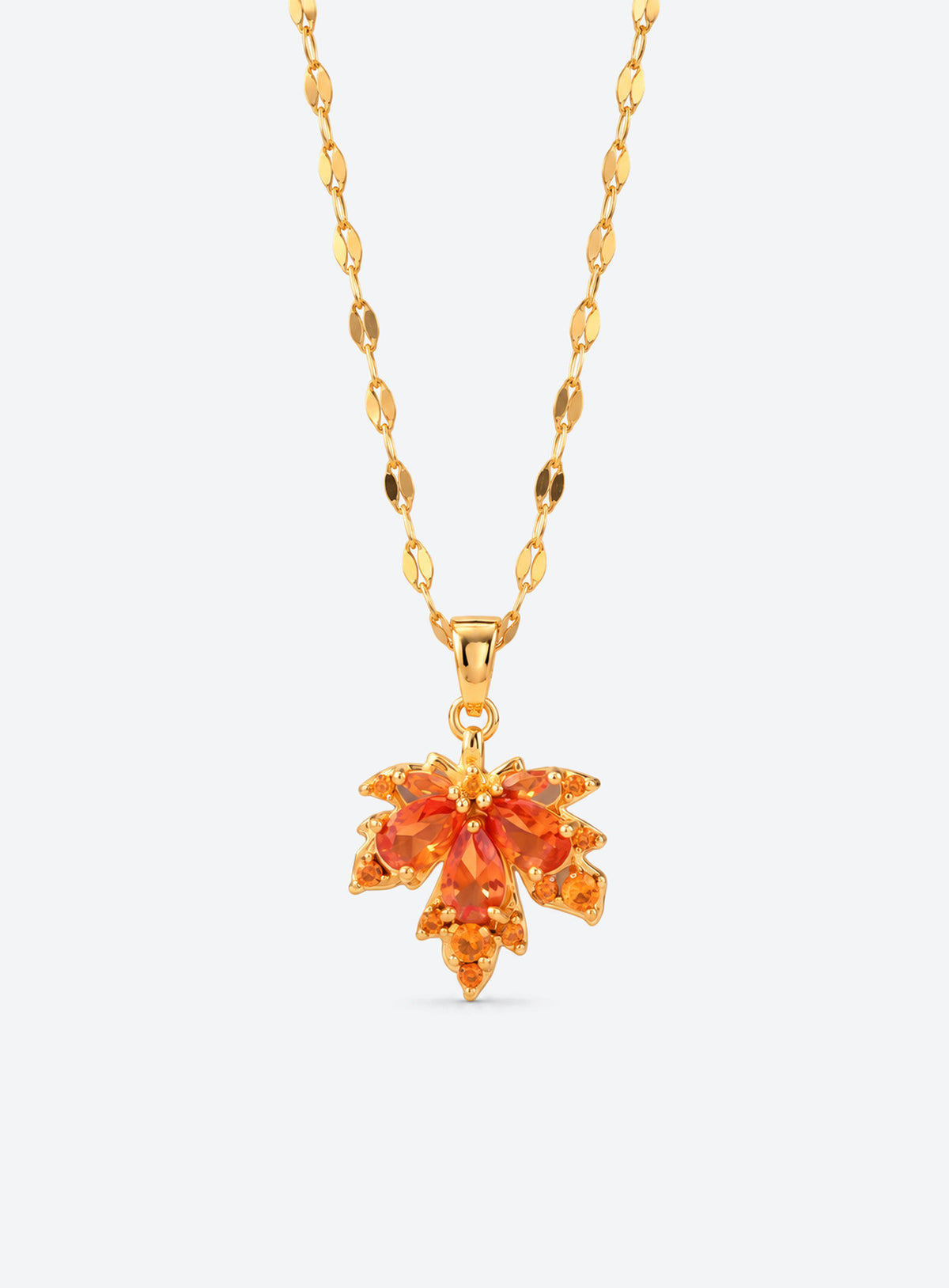 Orange crystal maple leaf pendant on a gold-tone leaf-link chain