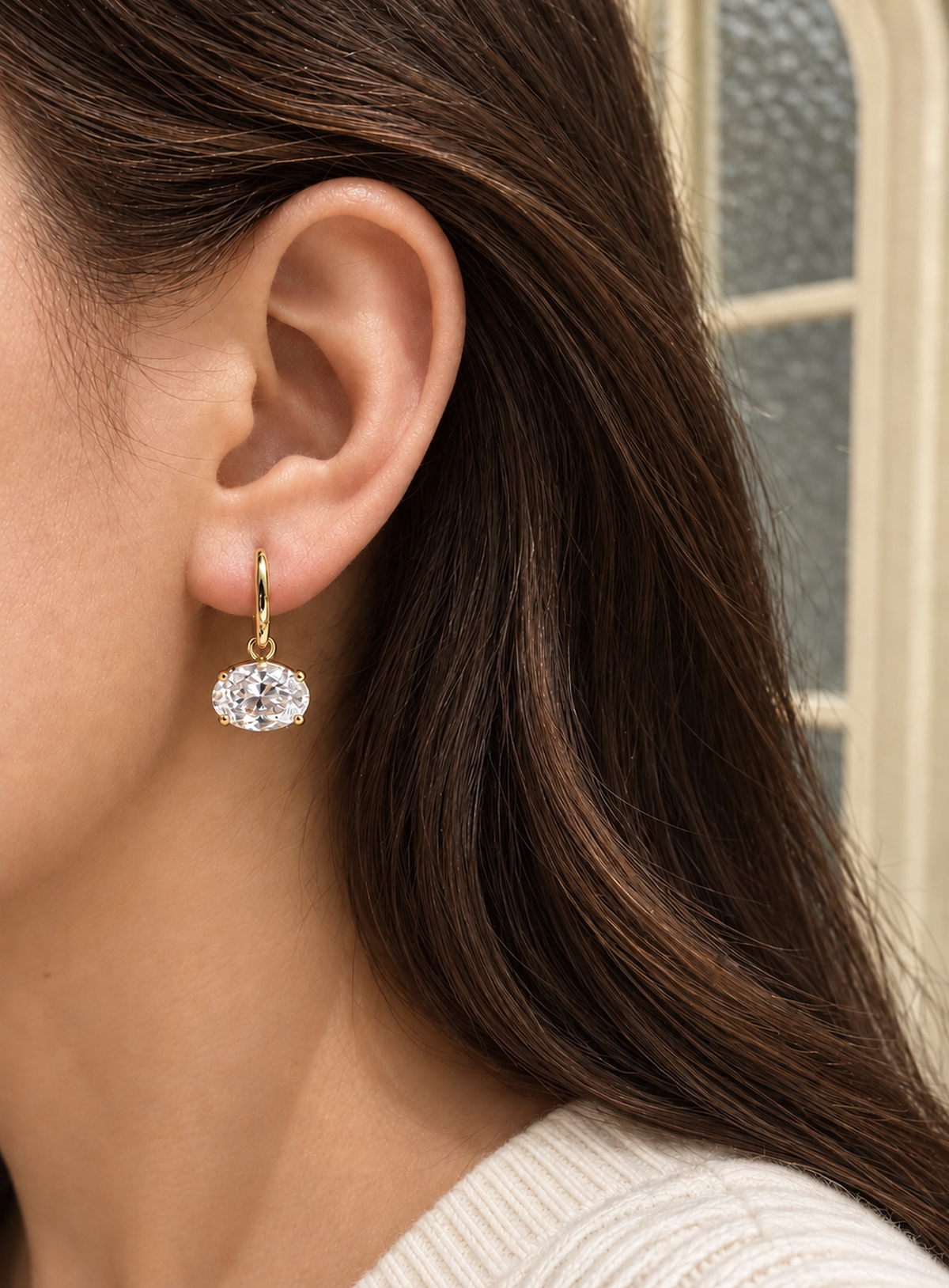 Gold-tone huggie earrings with suspended clear oval cubic zirconia drops