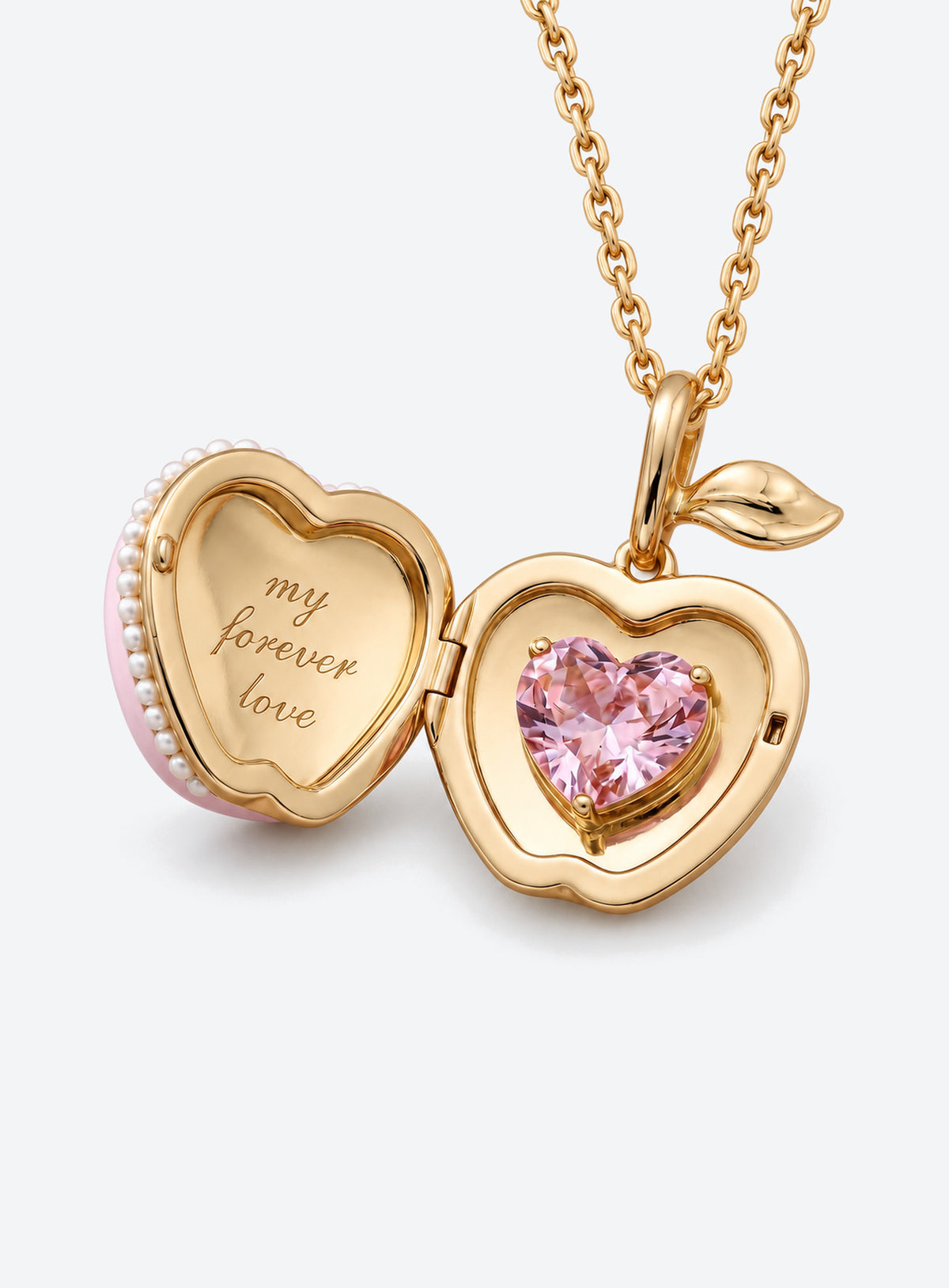Pink apple-shaped locket necklace with a leaf, flower detail and small white pearl-like trim