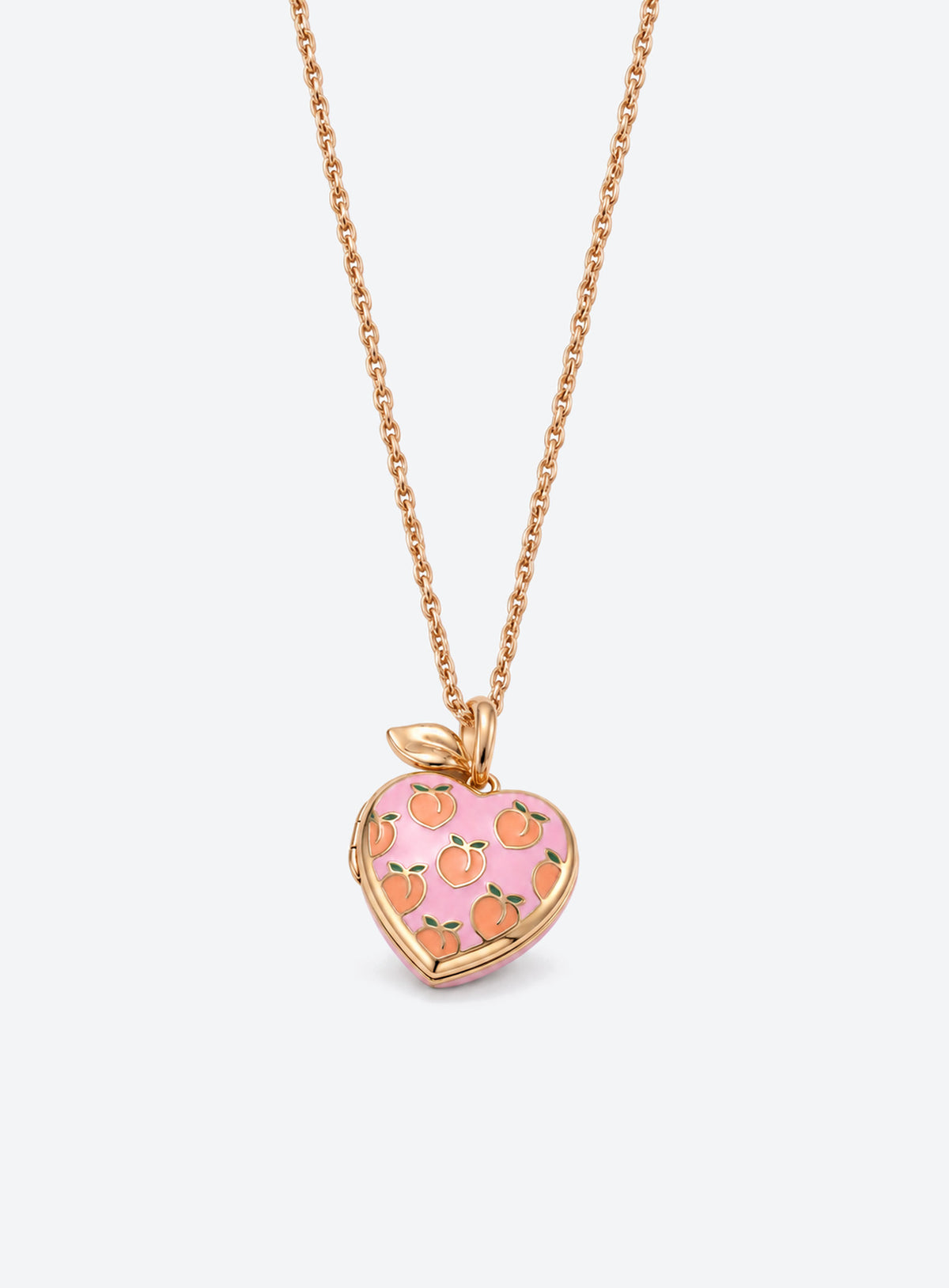 Pink heart locket necklace with gold-tone leaf detail at the top of the pendant (Peach)
