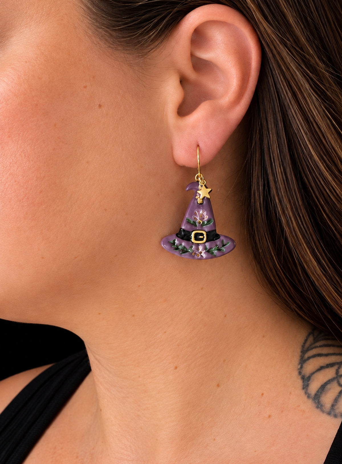 Pair of purple floral witch hat earrings with gold-tone hooks and star charms, black bands and gold-tone buckles