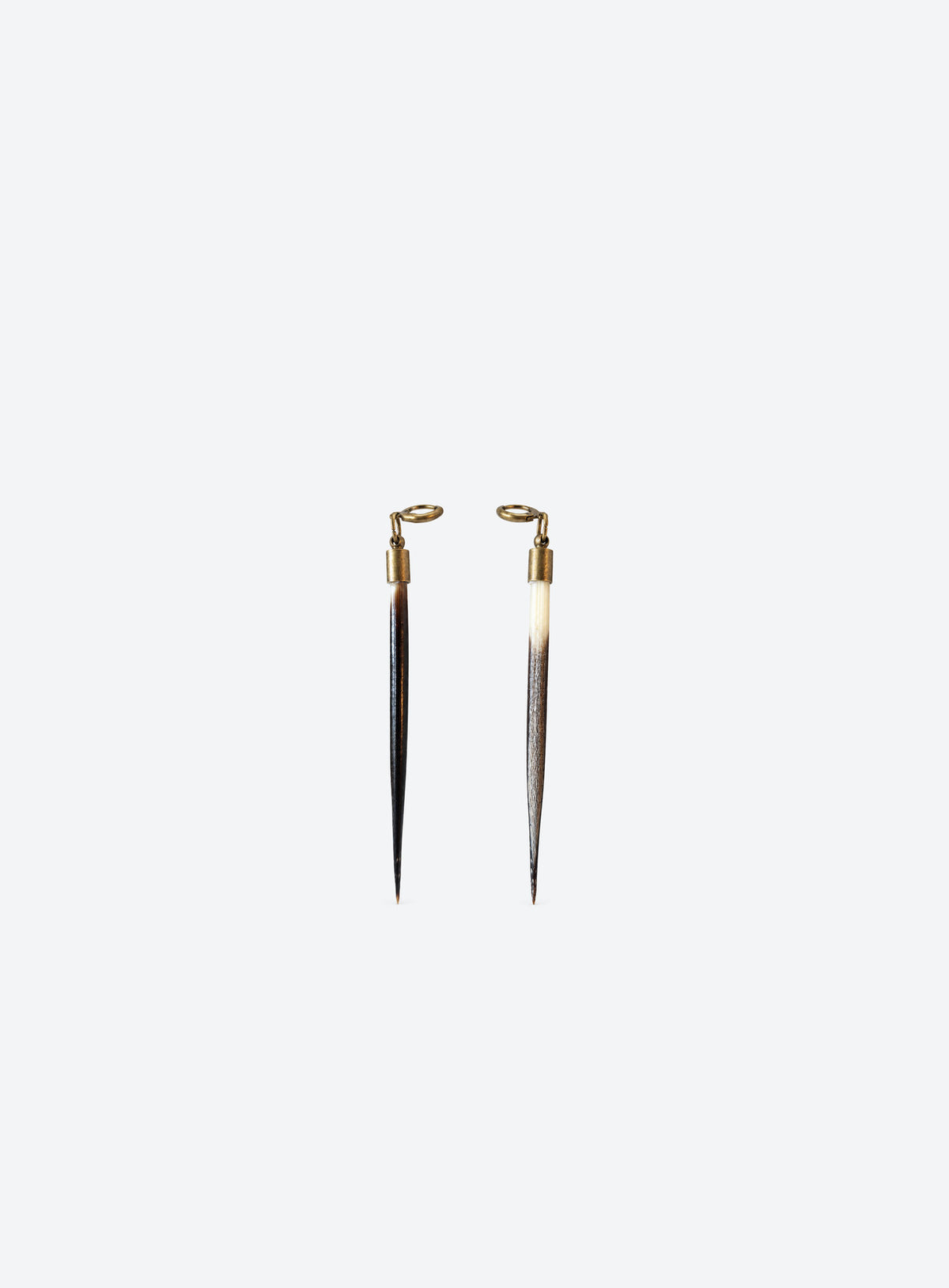Long quill-shaped drop earrings with pale tops, dark tips, and ear wires