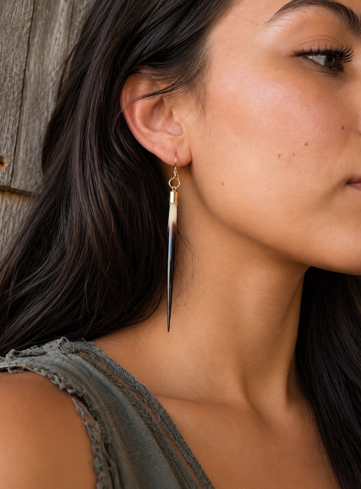 Long quill-shaped drop earrings with pale tops, dark tips, and ear wires