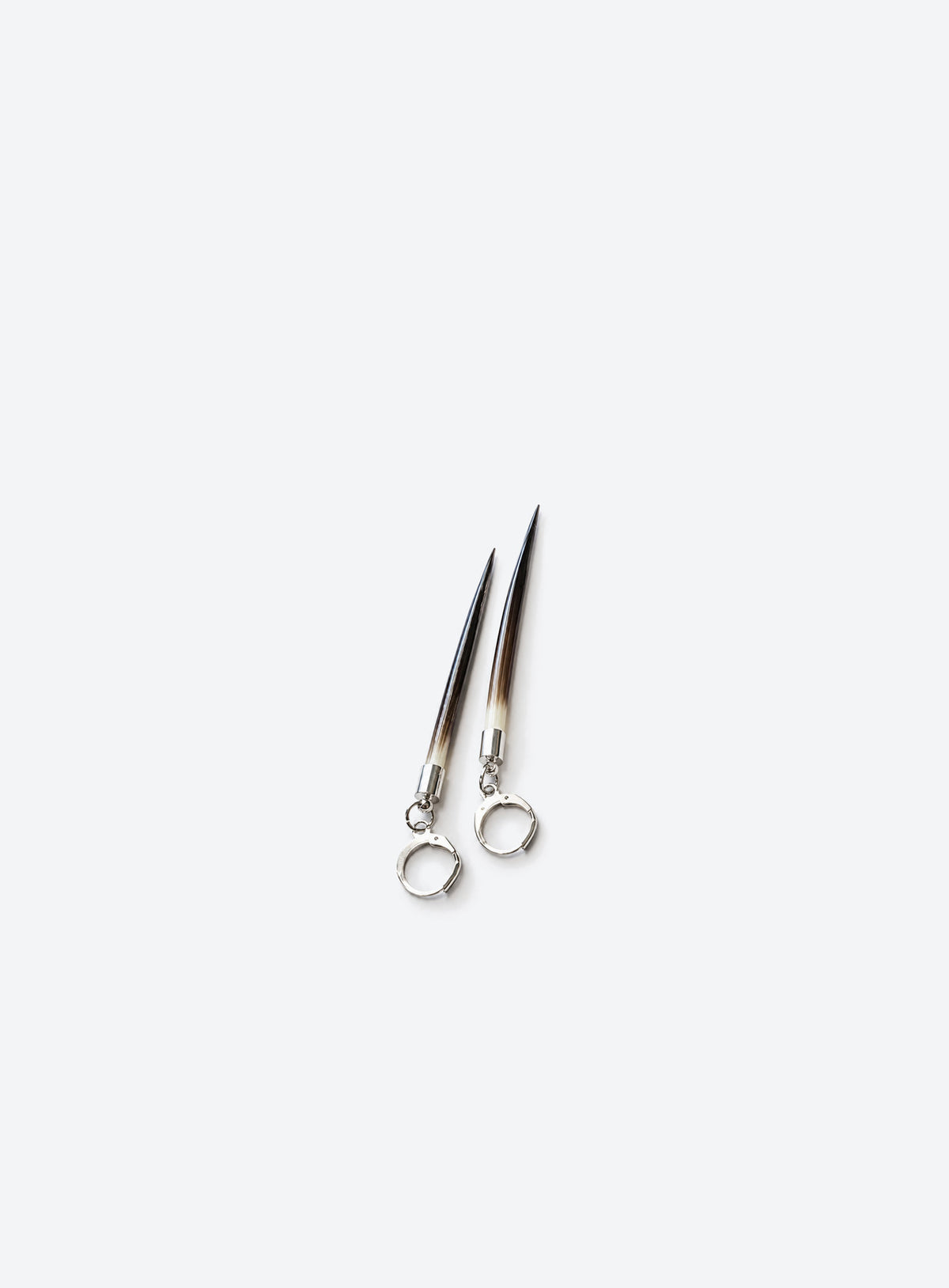 Long quill-shaped drop earrings with pale tops, dark tips, and ear wires