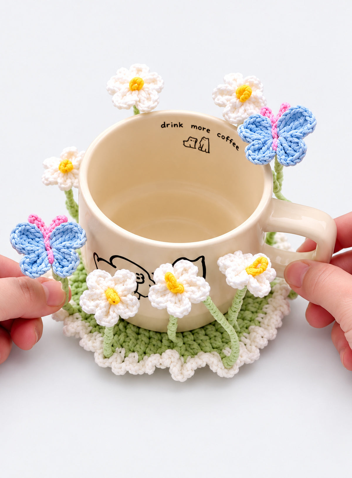 Handmade crochet coaster with raised decorative motifs around the edge (Daisy & Butterfly)