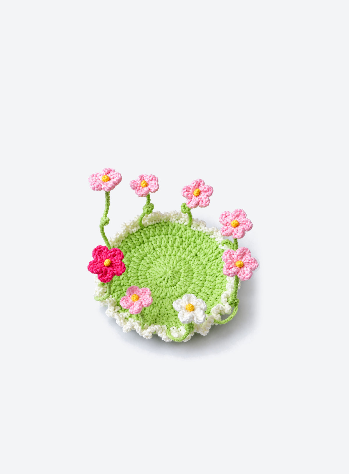 Handmade crochet coaster with raised decorative motifs around the edge (Pink Daisies)