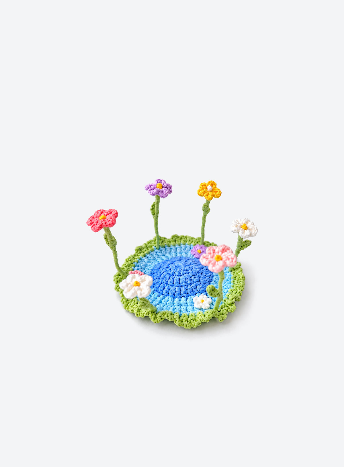 Handmade crochet coaster with raised decorative motifs around the edge (Mixed Daisies)