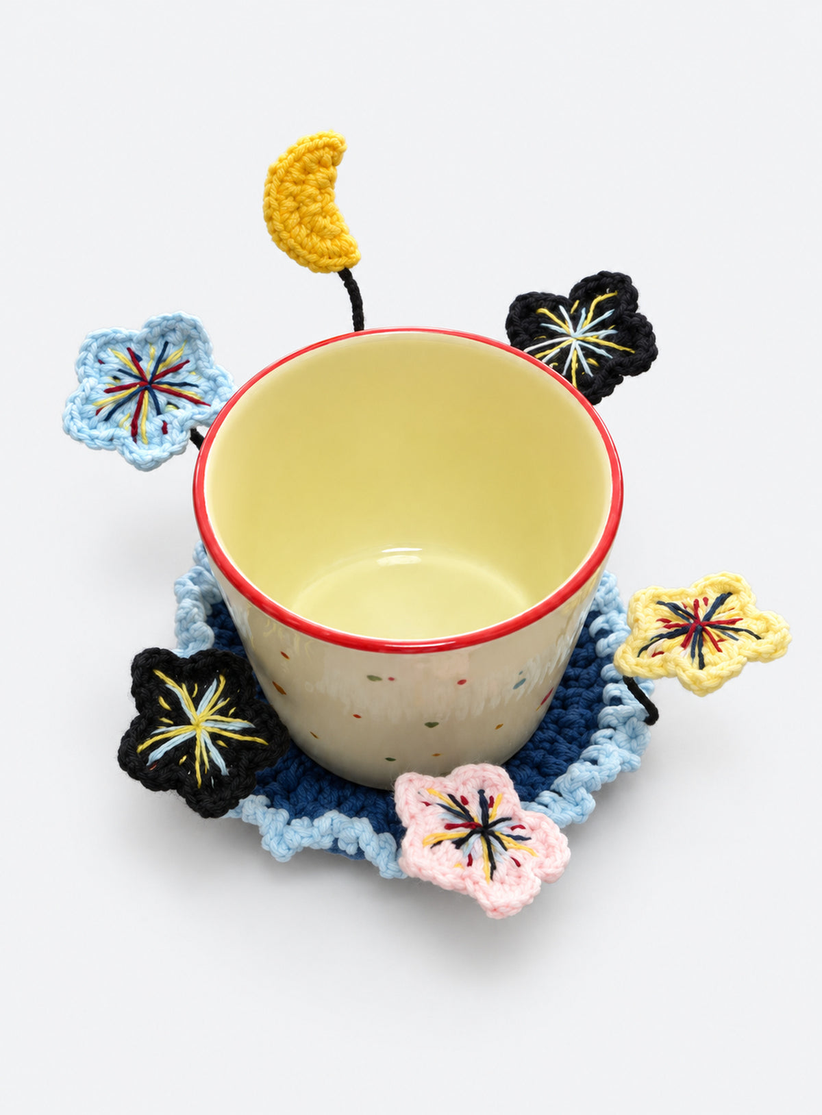 Handmade crochet coaster with raised decorative motifs around the edge (Moon & Colorful Stars)