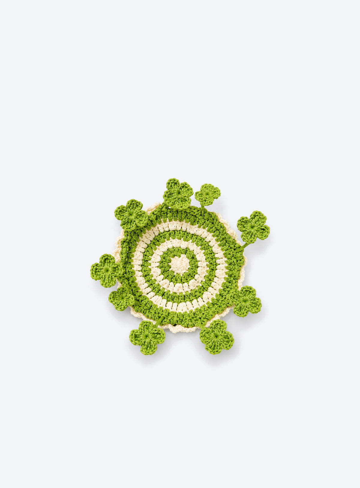 Handmade crochet coaster with raised decorative motifs around the edge (Four-Leaf Clover)