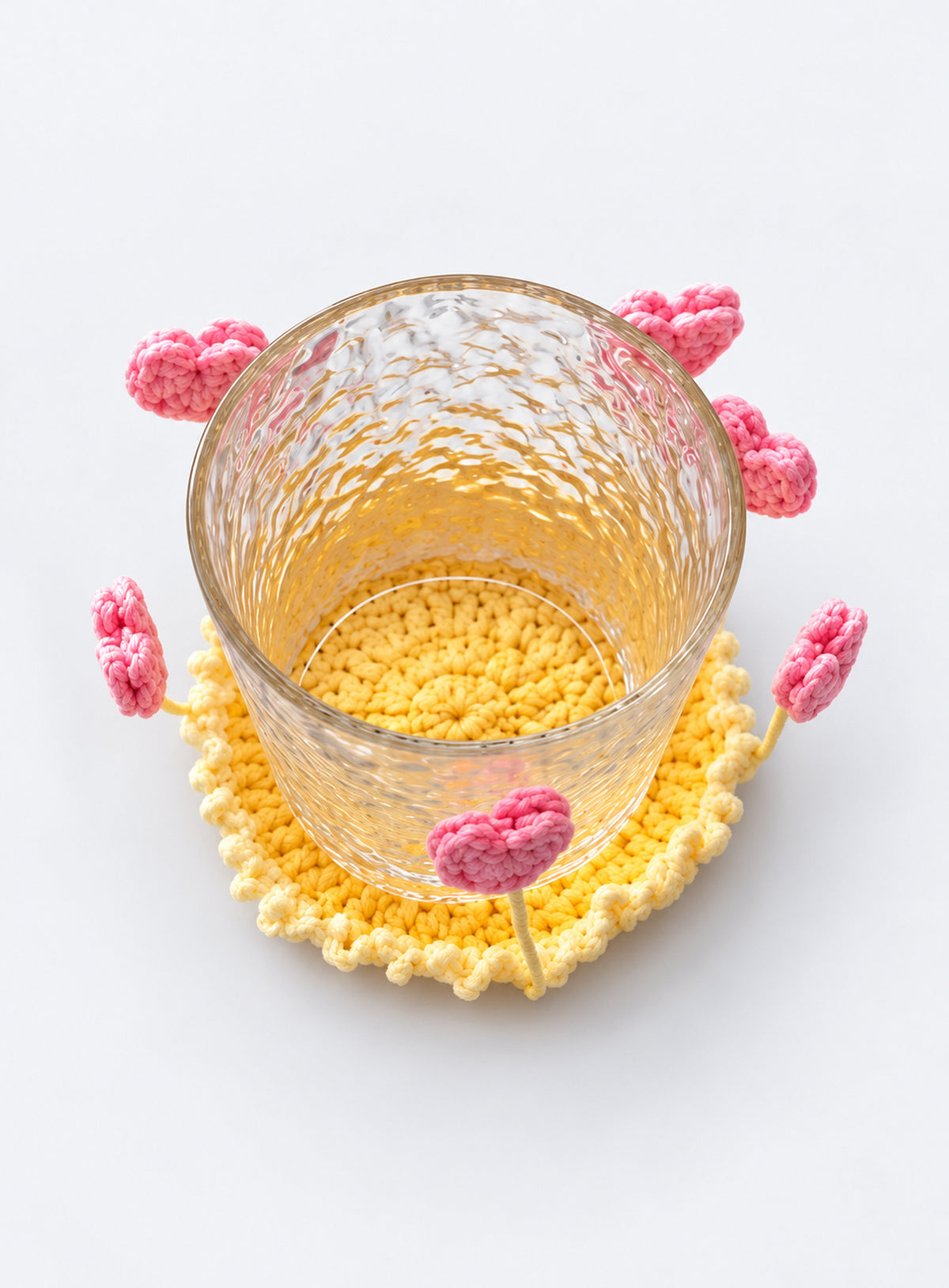Handmade crochet coaster with raised decorative motifs around the edge (Heart)