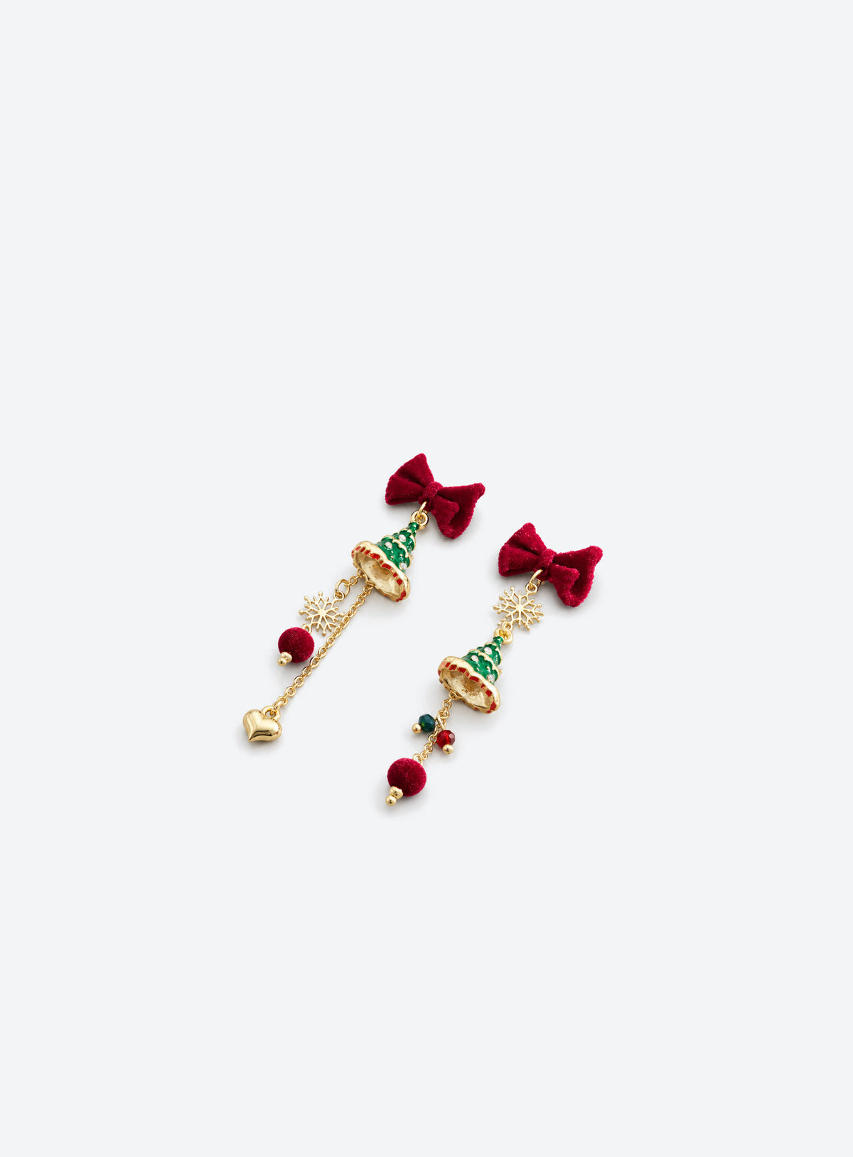Asymmetric earrings with red velvet bows, green trees, gold-tone chains, snowflakes, red pom-poms and a heart