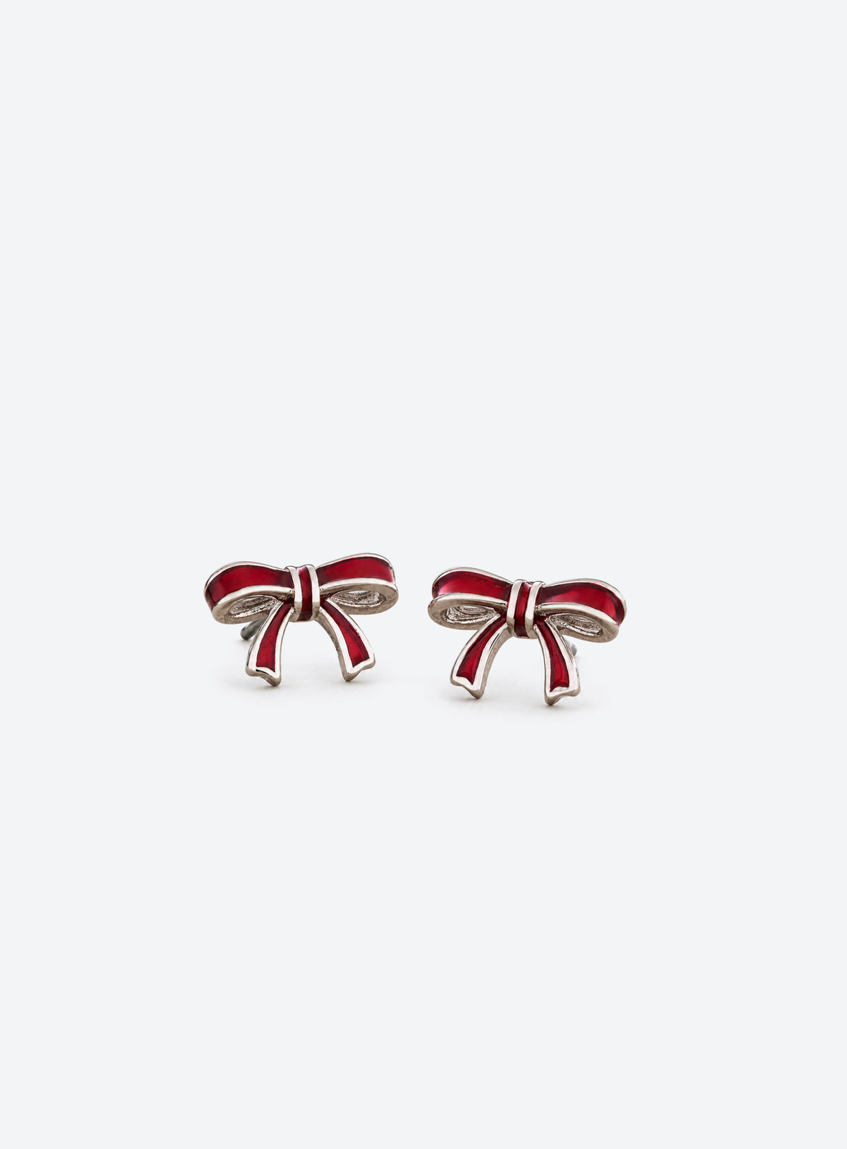 Pair of red enamel bow stud earrings with vintage silver-tone edges