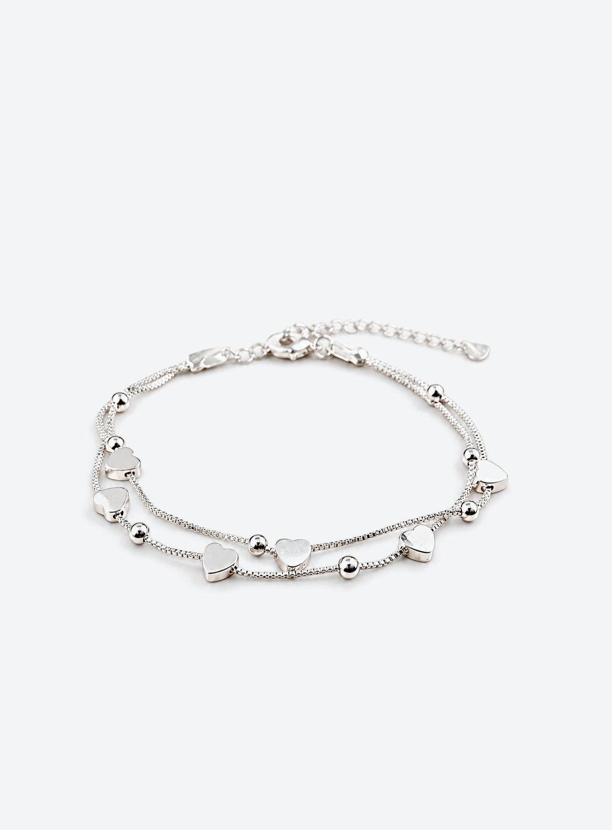 Sterling silver chain bracelet with six heart-shaped beads and an adjustable lobster clasp