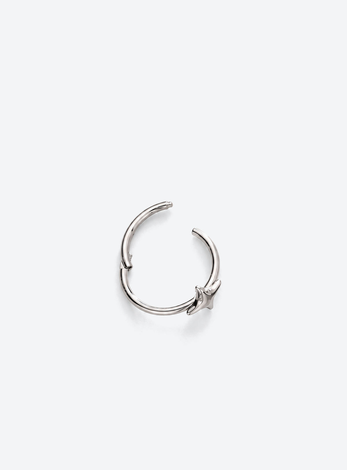 Star detail nose hoop with hinged clicker closure, shown in a studio product photo (Silver)